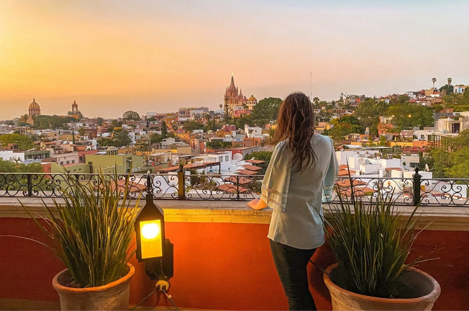 Woman on balcony looking over centro san miguel de allende. Stem Cell Therapy Mexico San Miguel de Allende