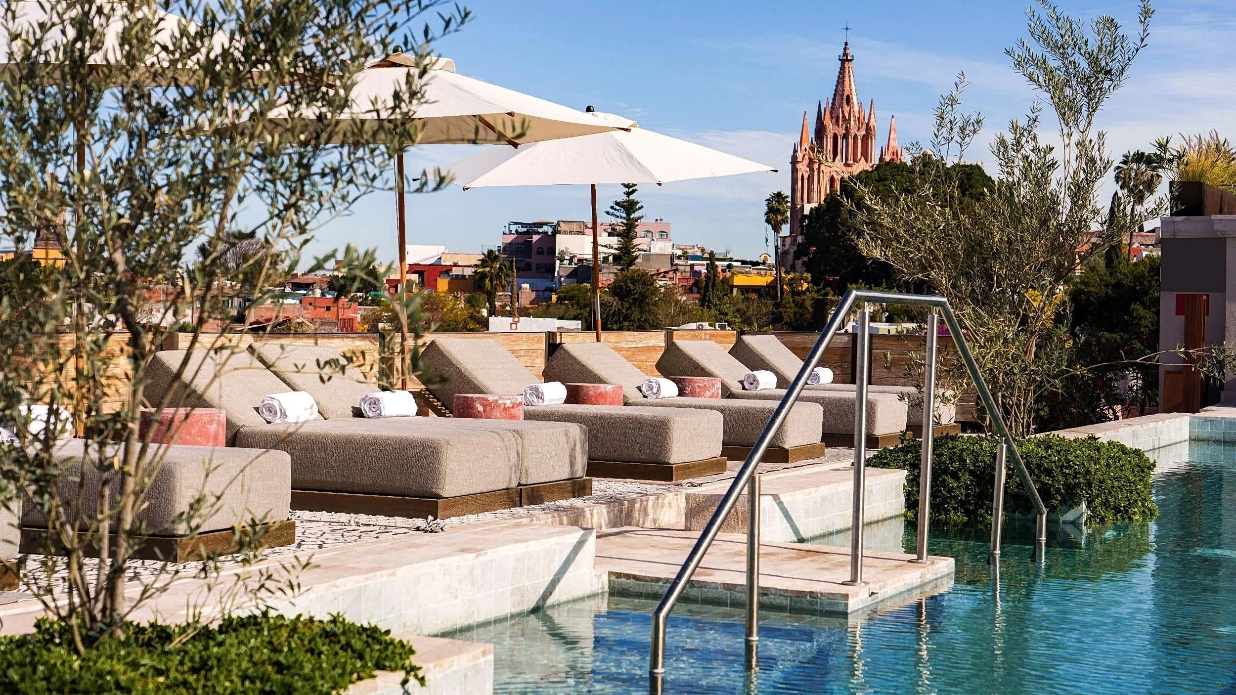 The roof top pool with sun lounges and Parroquia in background at the Numu hotel Hyatt group in San Miguel de Allende Mexico where we do stem cell therapy.