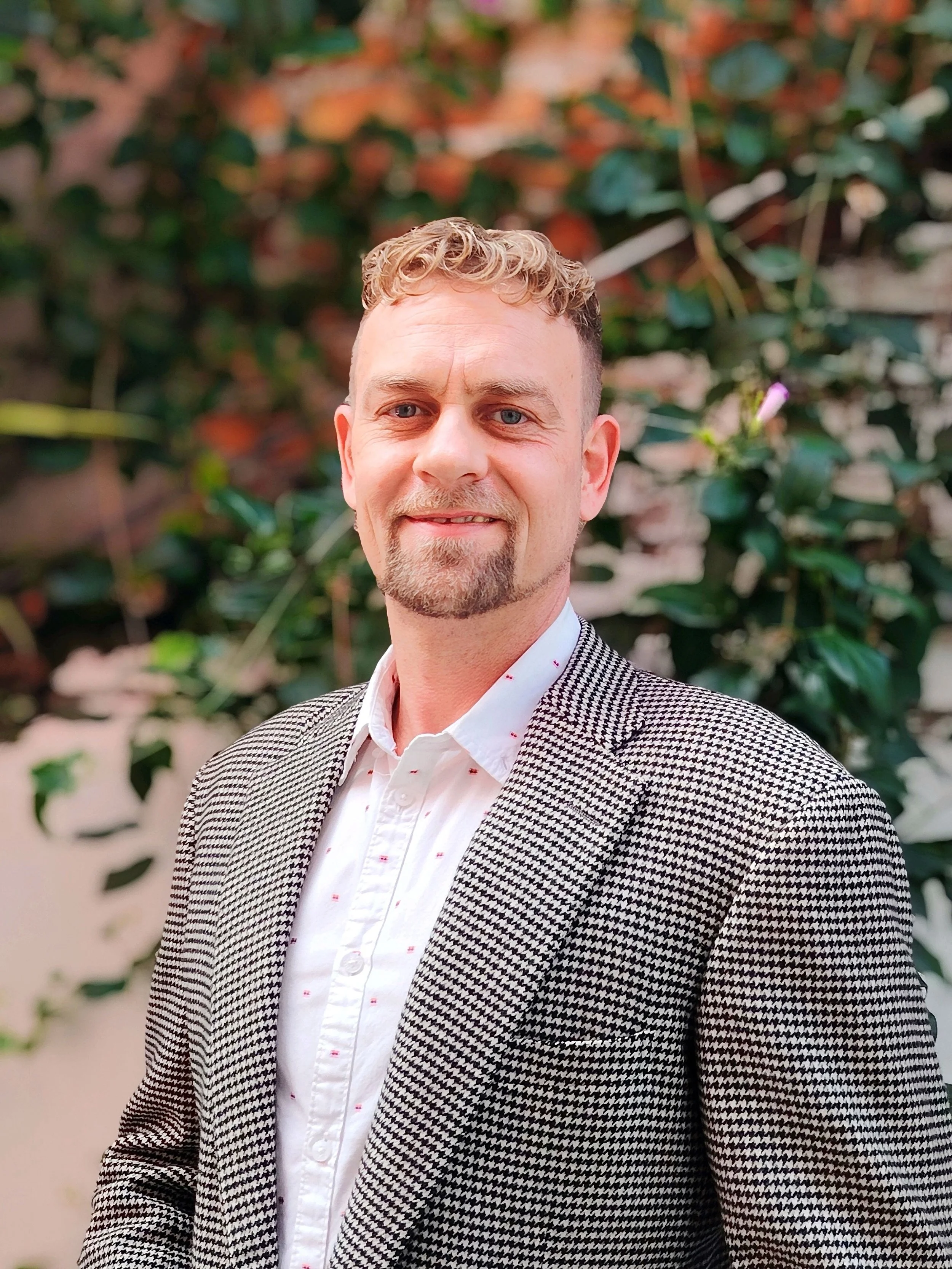 Danyel Kriehl blonde hair blue eyes CEO and Founder at Stems for Life  in a black and white suit with white and pink shirt.