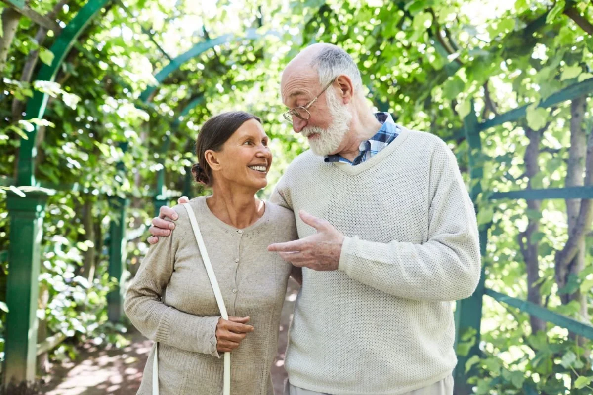 older couple walking outdoors after stem cell therapy with improved mobility
