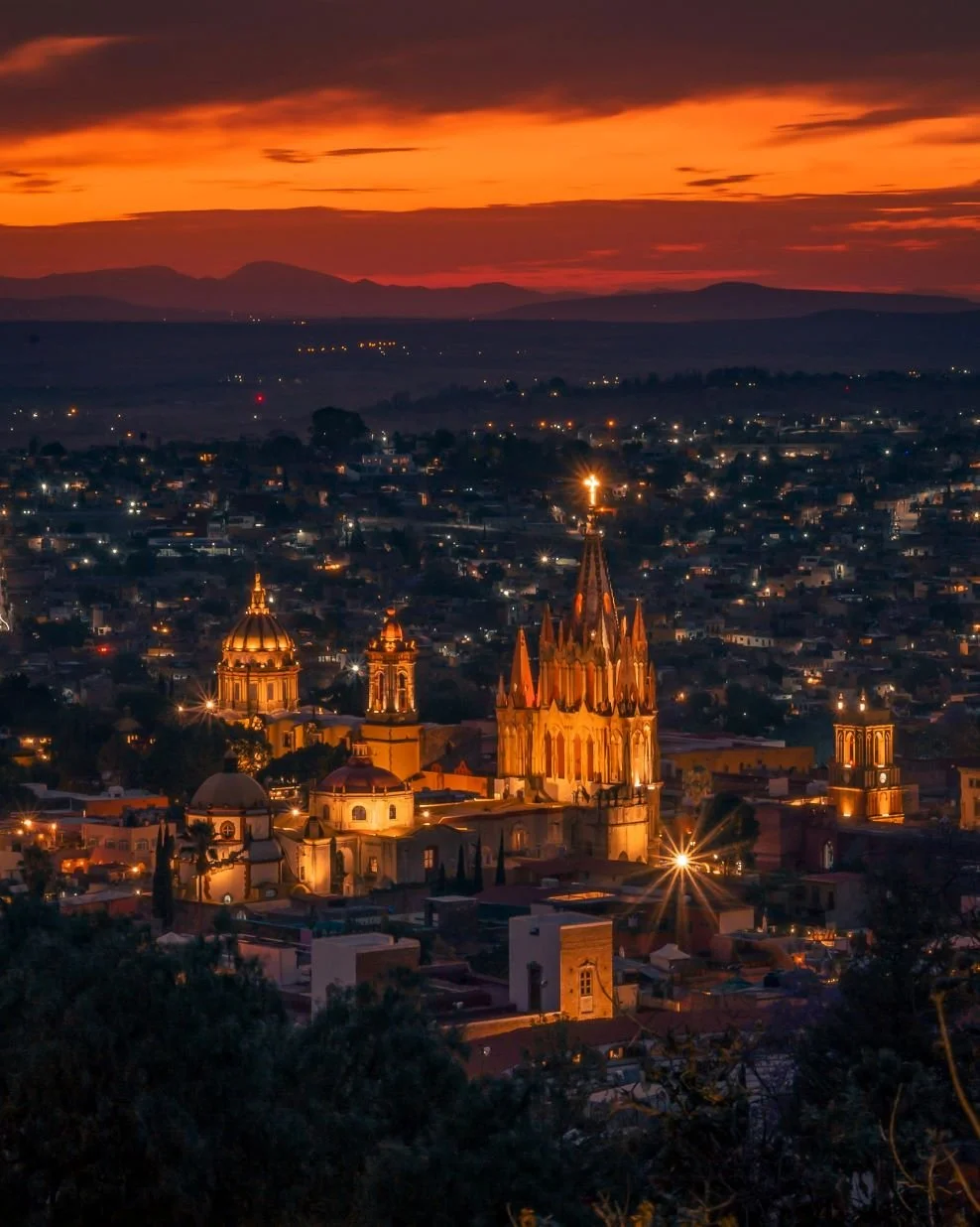 sunset view of San Miguel de Allende city with illuminated cathedral skyline