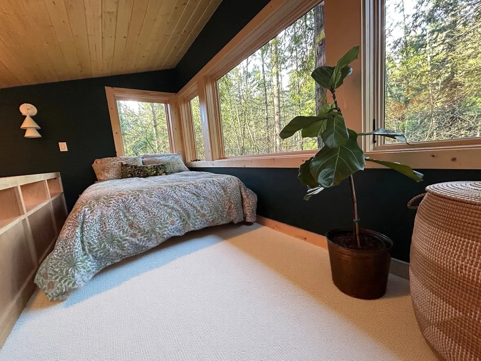ADU loft with bed, rug and plants