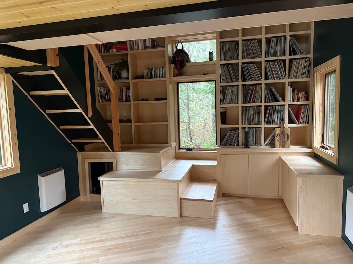 ADU empty interior with maple bookshelves, pedestals, steps and vinyl record storage