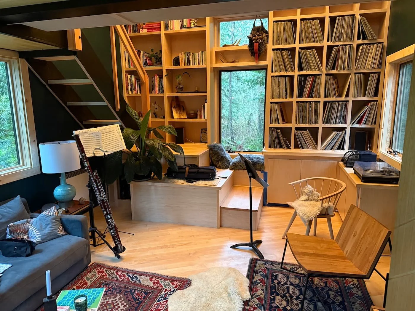 Interior of Black ADU with maple pedestals, maple built-in bookcases with vinyl record storage