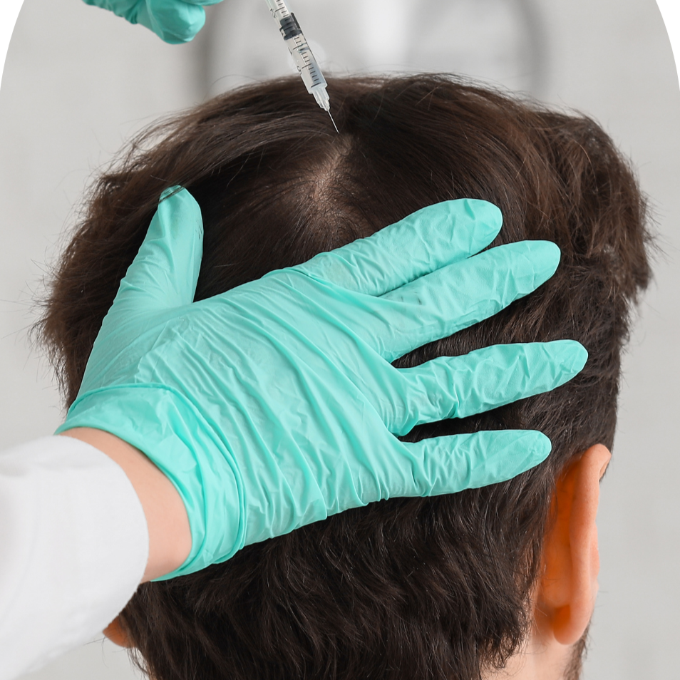A healthcare professional wearing teal gloves administering a shot to the back of a person's head.