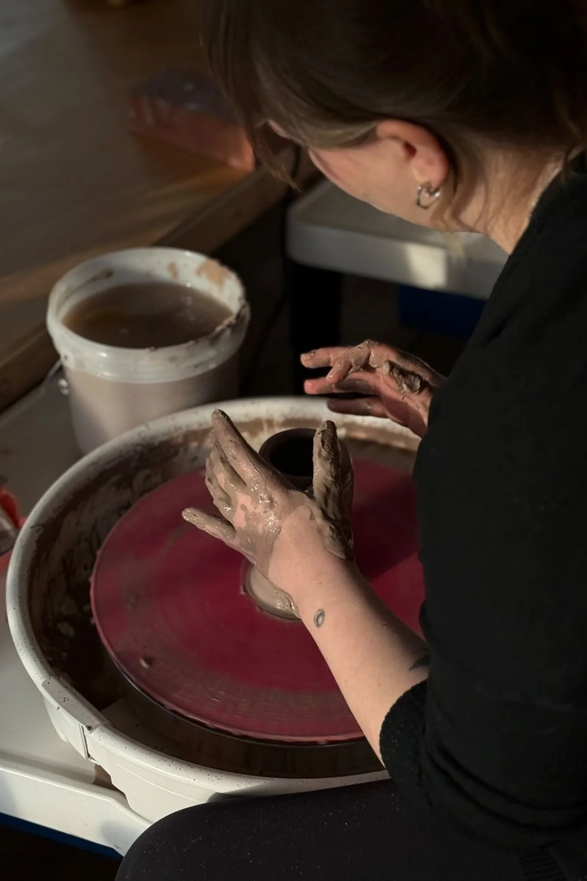 Amanda Cronin, NY-based ceramic artist, at work on the wheel.