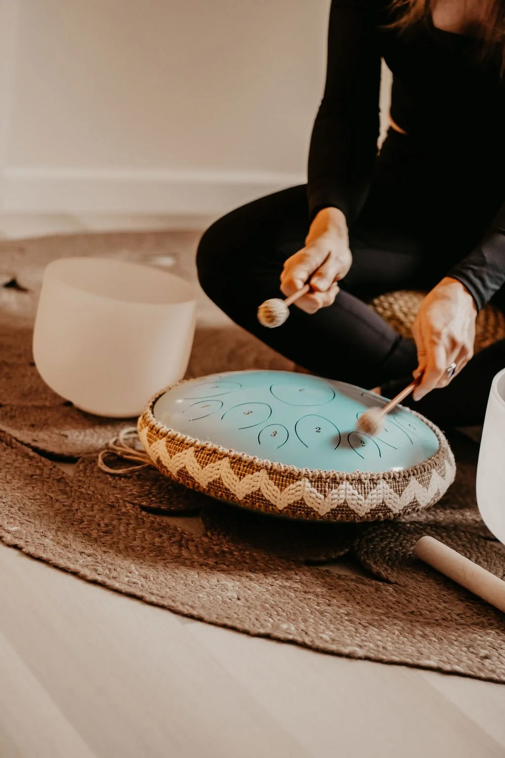 Woman playing a sound healing drum