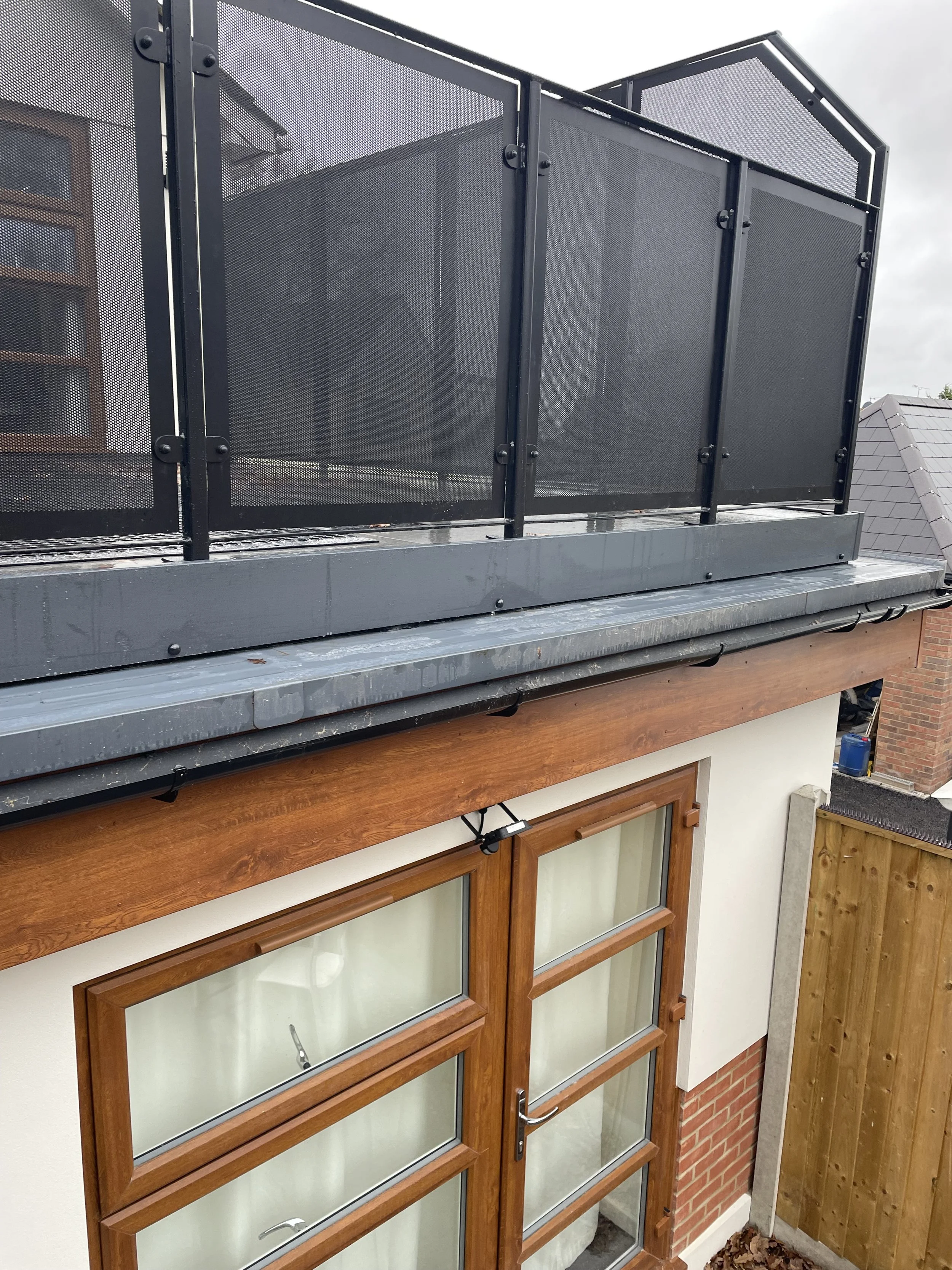 Image of fascia, soffits and gutters and plastic trim on porcelain tiled deck