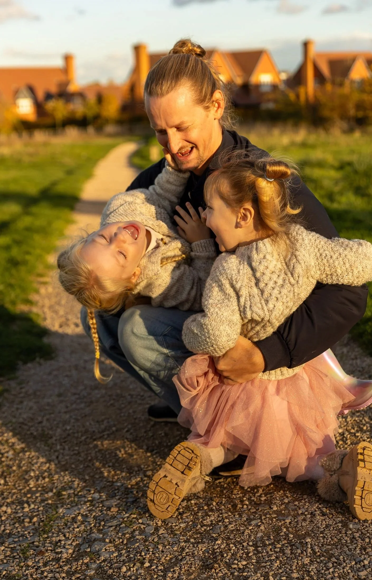 outdoor family photo, father with two daughters at golden hour in surrey park