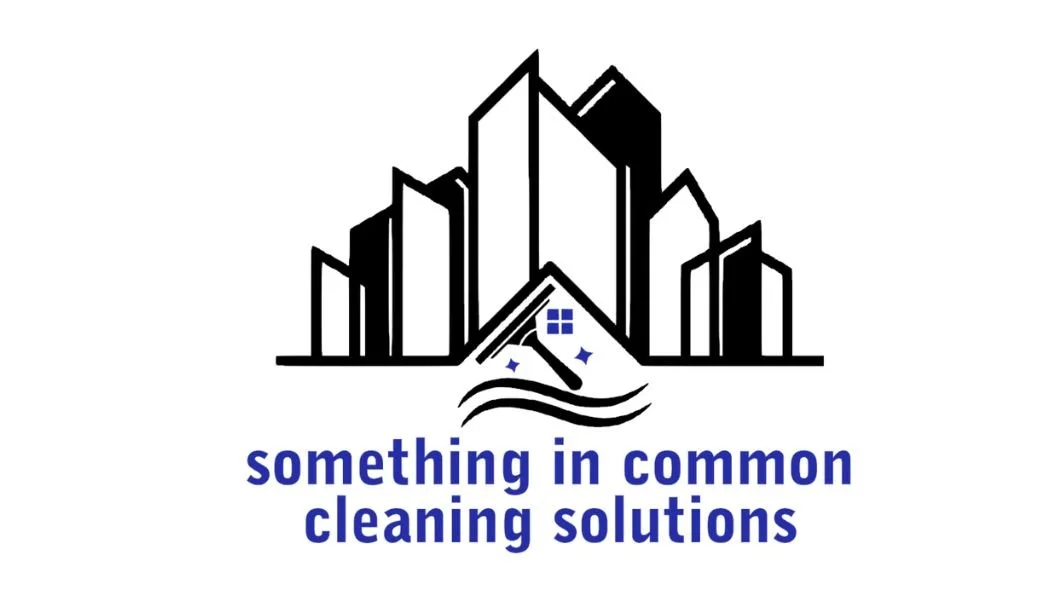 Logo with stylized city buildings, a cleaning mop, sparkles, and waves, with the text 'something in common cleaning solutions' underneath.