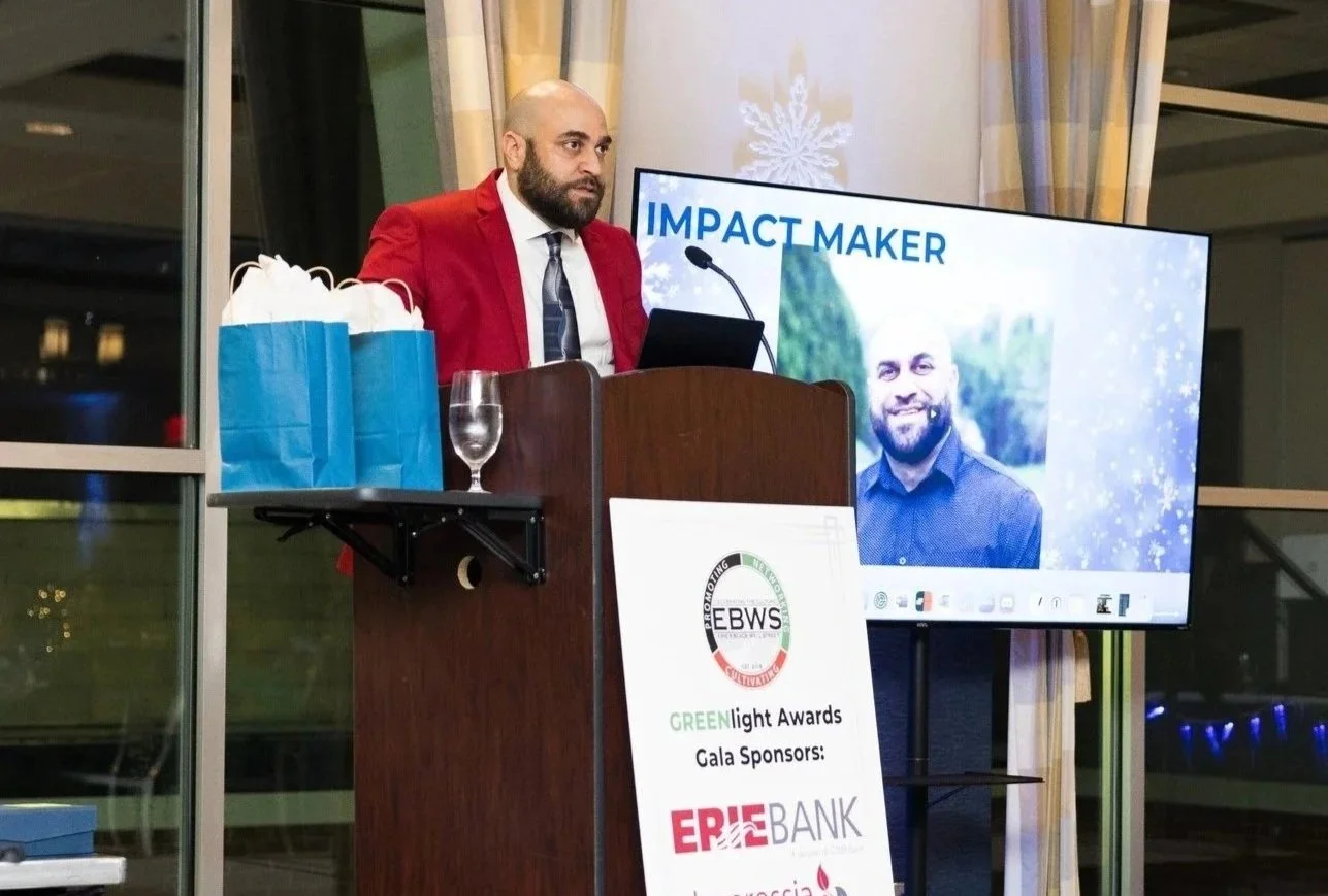 Man standing at a podium accepting an award.