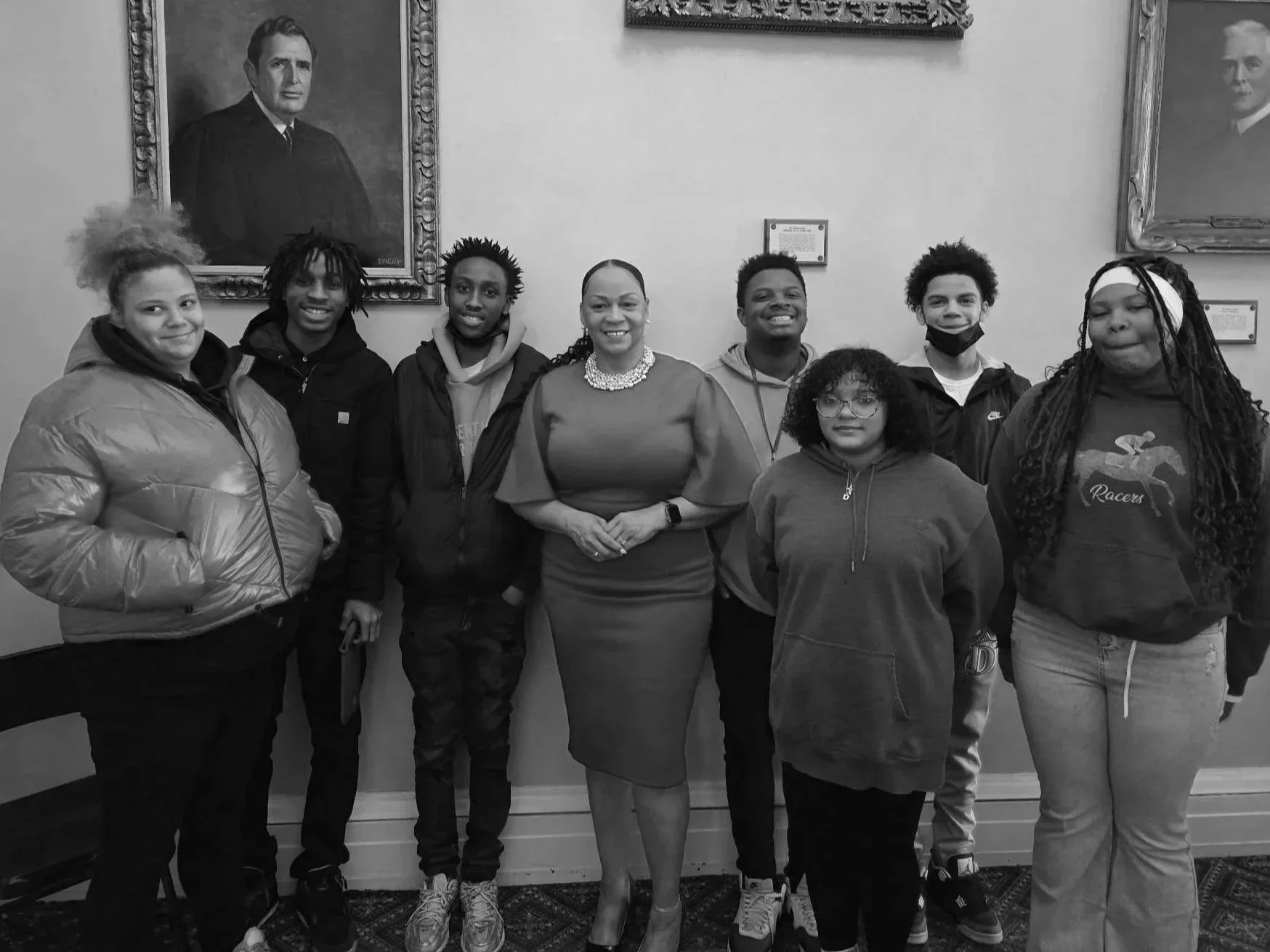Group of high school aged students with a Judge in the center.
