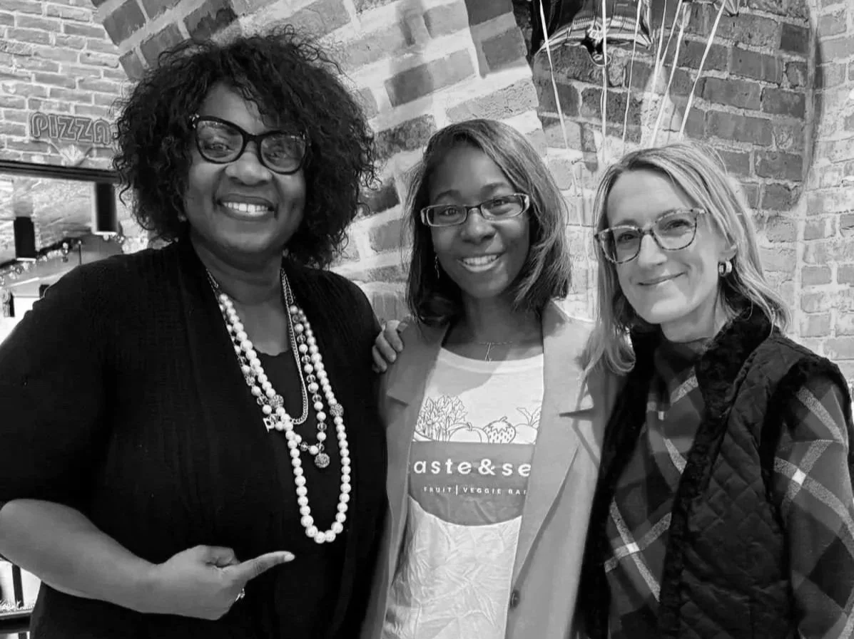 Three women smiling.