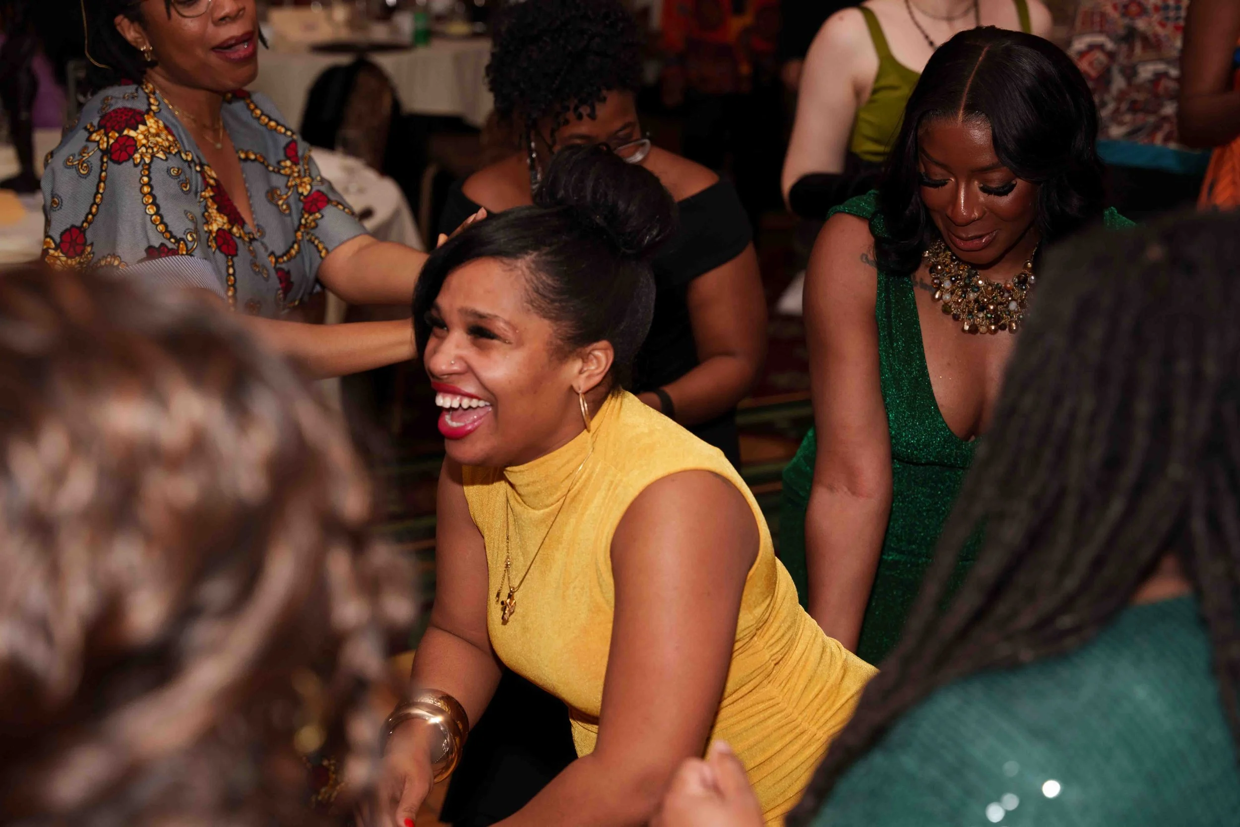 Young woman smiling and dancing, surrounded by other women dancing.