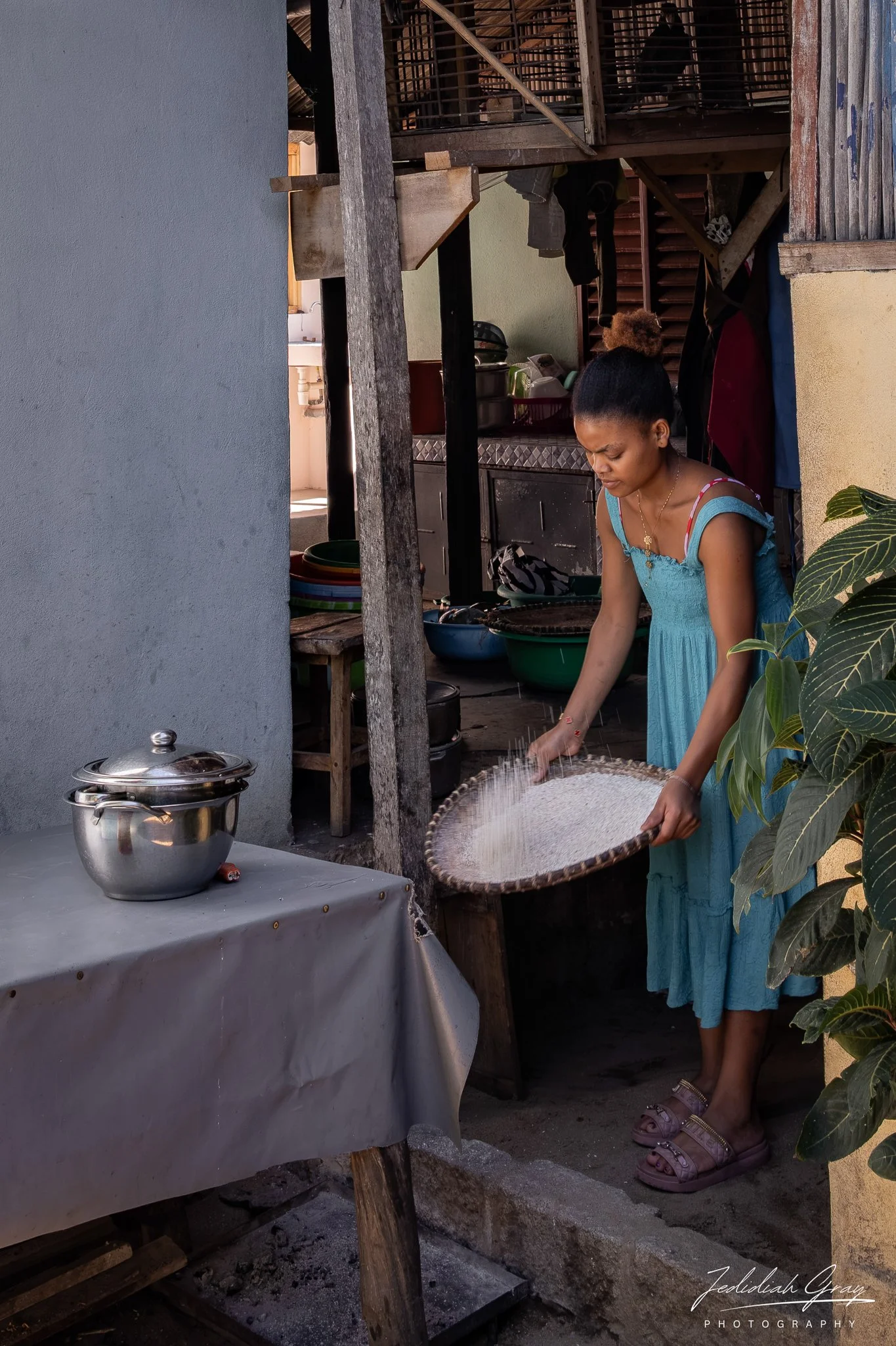 A woman winnowing rice 