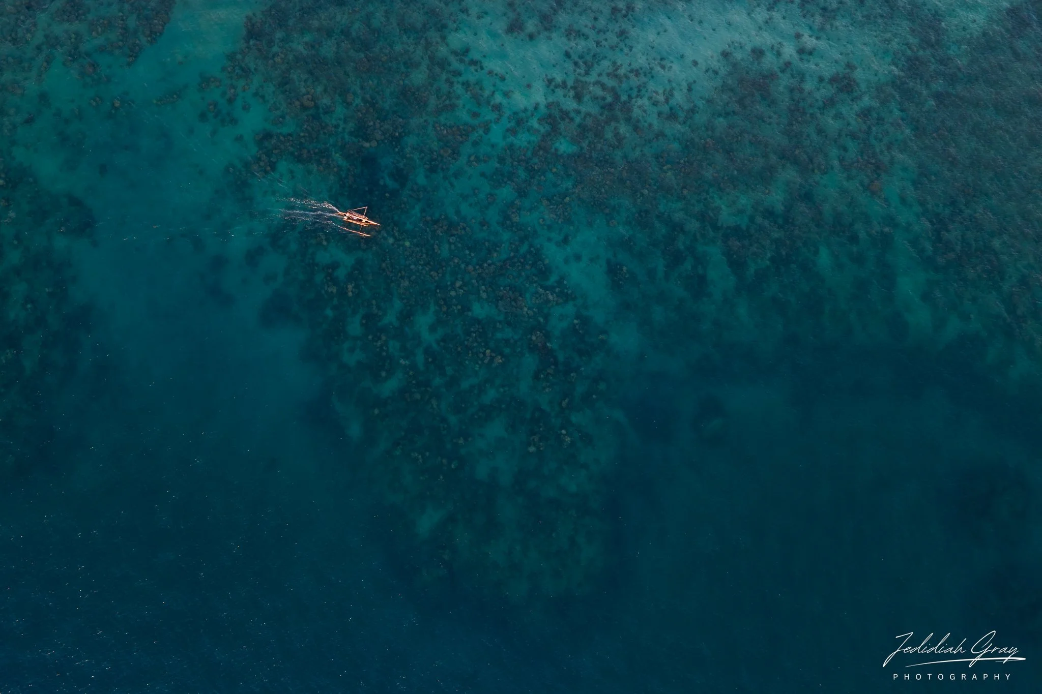 Aerial view of a pirogue sailing off the coast of Nosy Komba