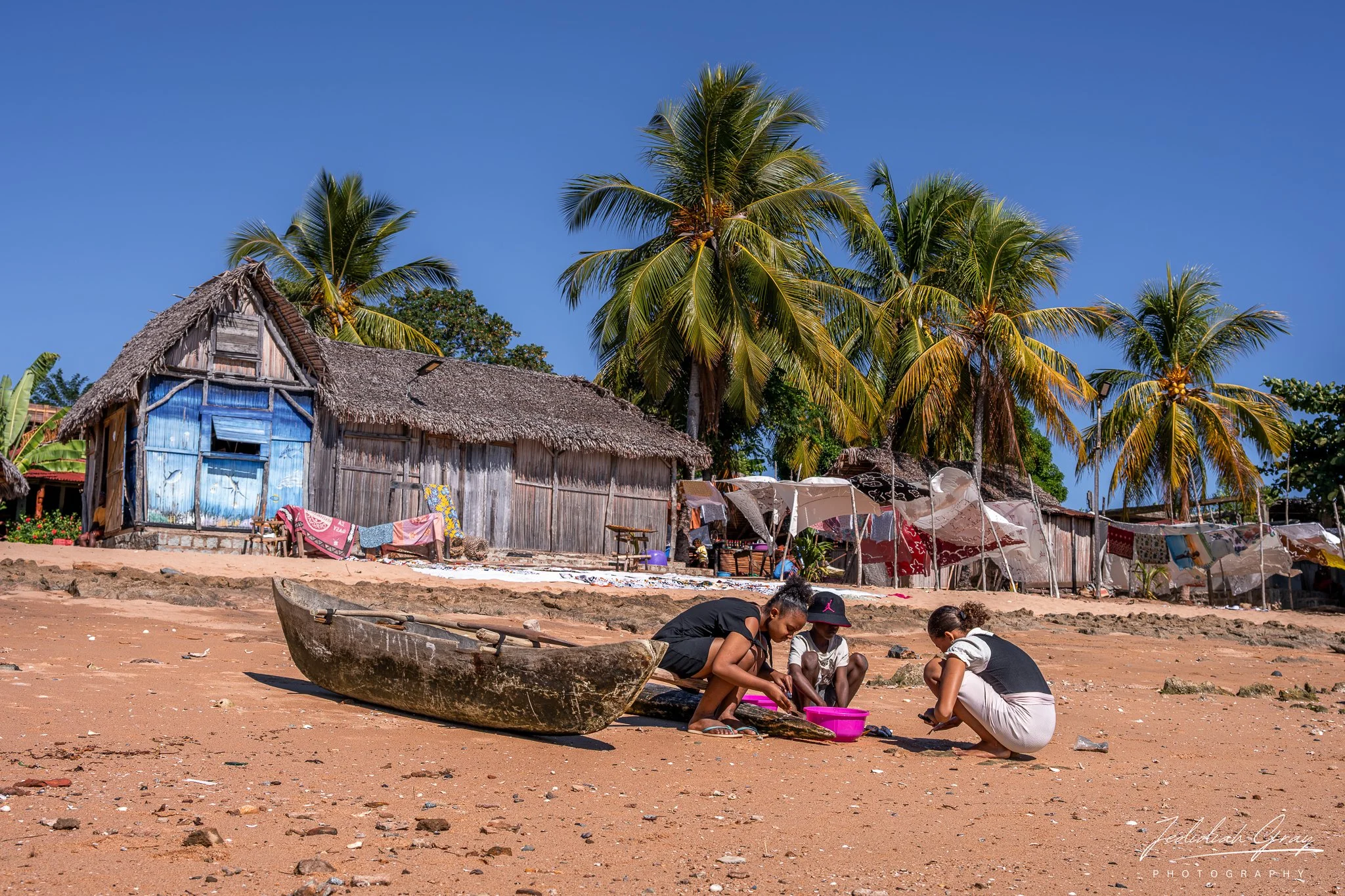 Locals prepare freshly caught fish on the beach on Nosy Komba