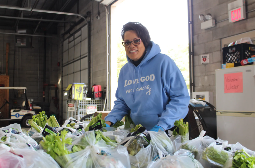 An employee packs bags at a food pantry