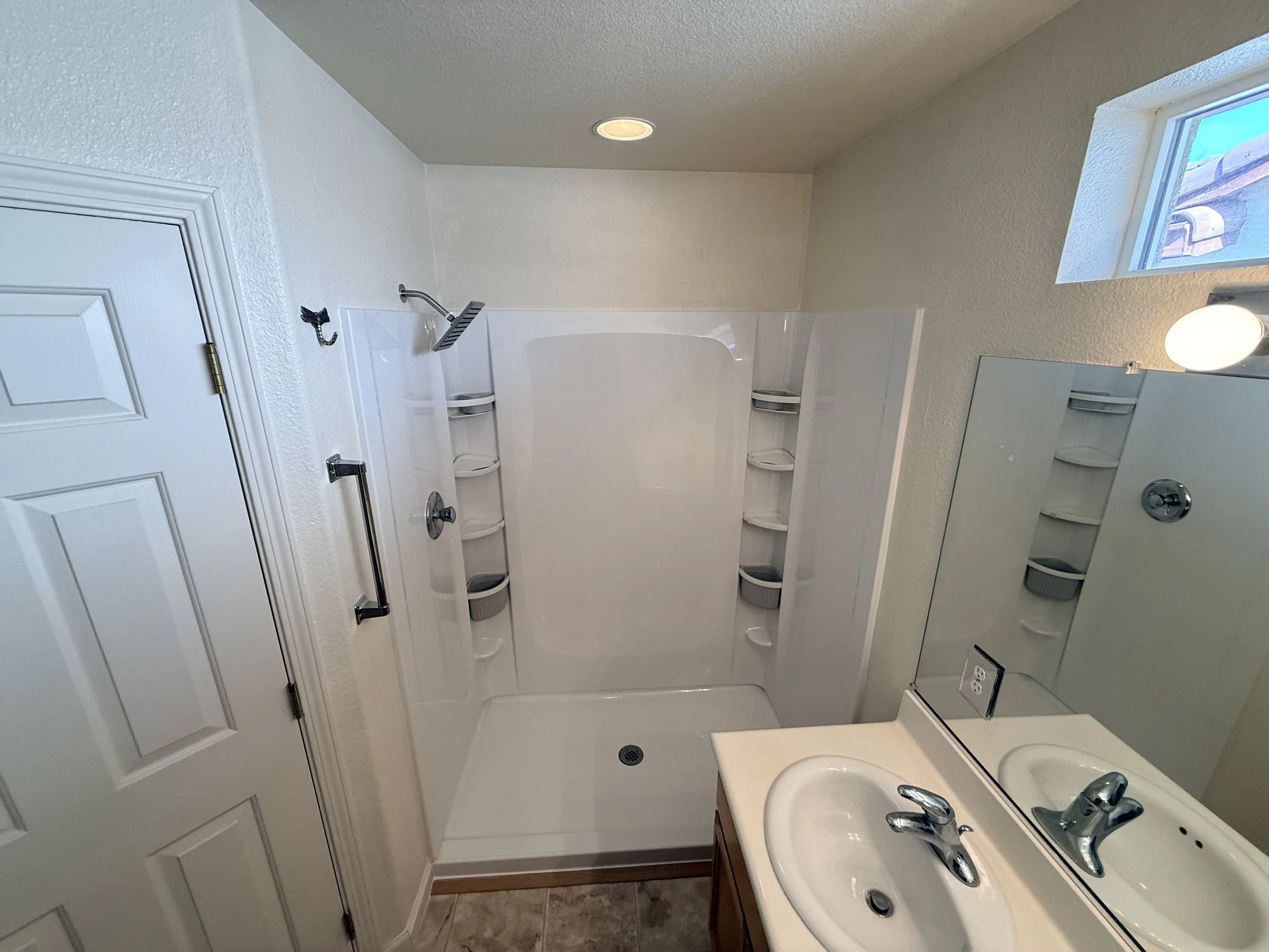 Shower Renovation 8 - New system installed, walls patched, textured and paint matched, and shower trimmed out.