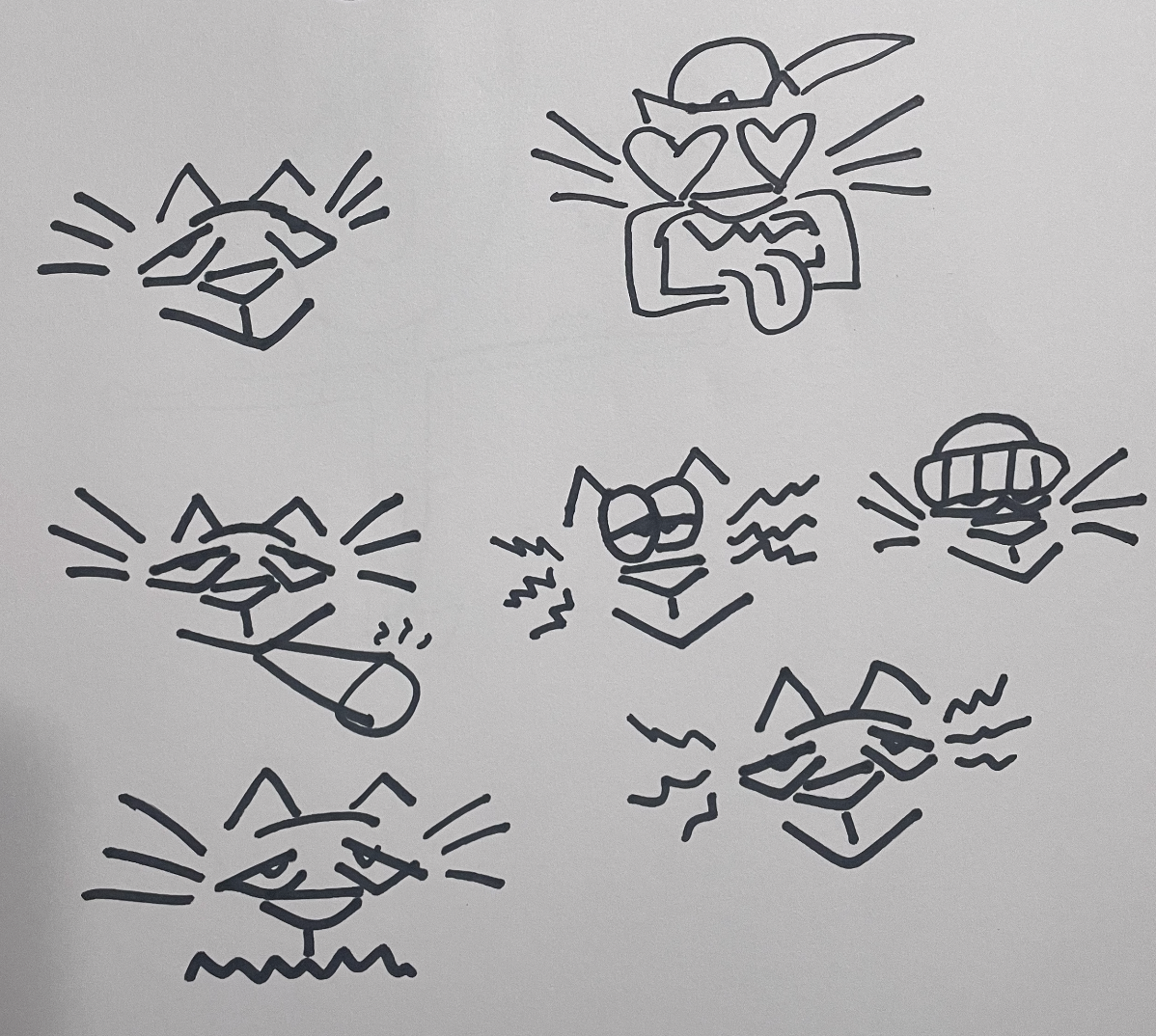 A sheet of paper with eight cartoon cats drawn in black ink, each with different facial expressions and accessories.