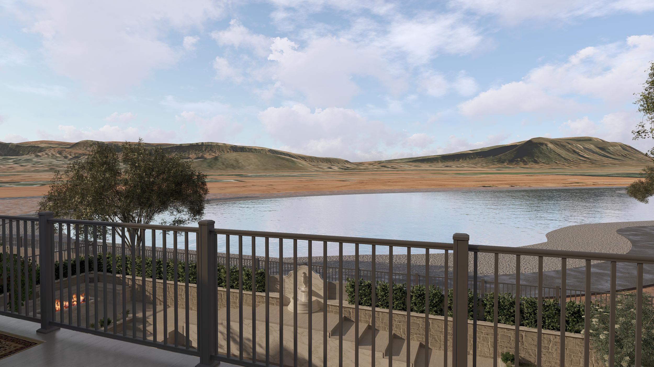 View from a balcony overlooking a lake with hills and a partly cloudy sky in the background. There is a small fire pit and a decorative fountain on the balcony.
