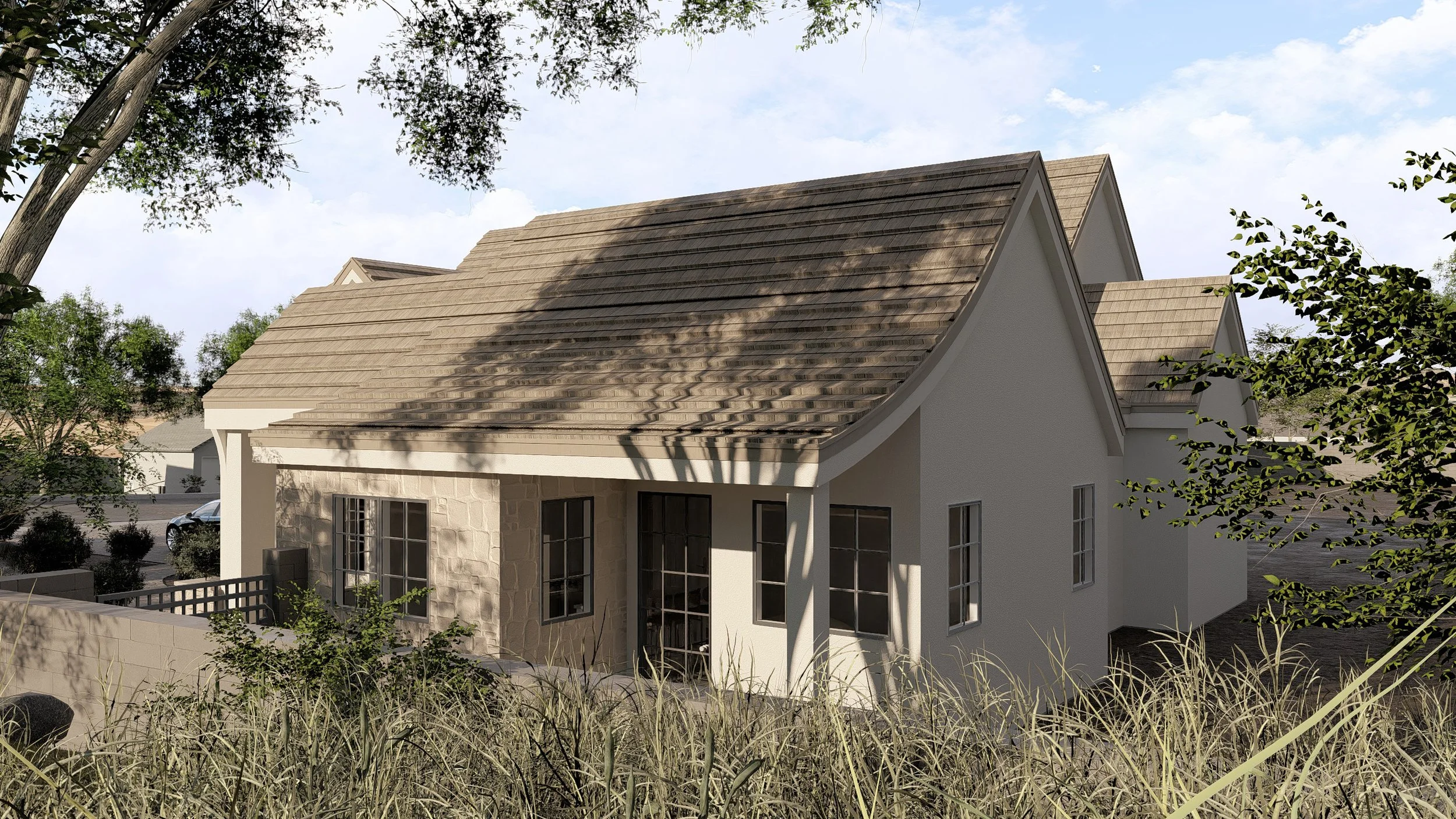 A house with a beige roof, white walls, and multiple windows, set among trees and dry grass.