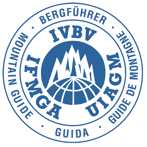 Logo of the International Federation of Mountain Guides Associations with mountain and globe imagery