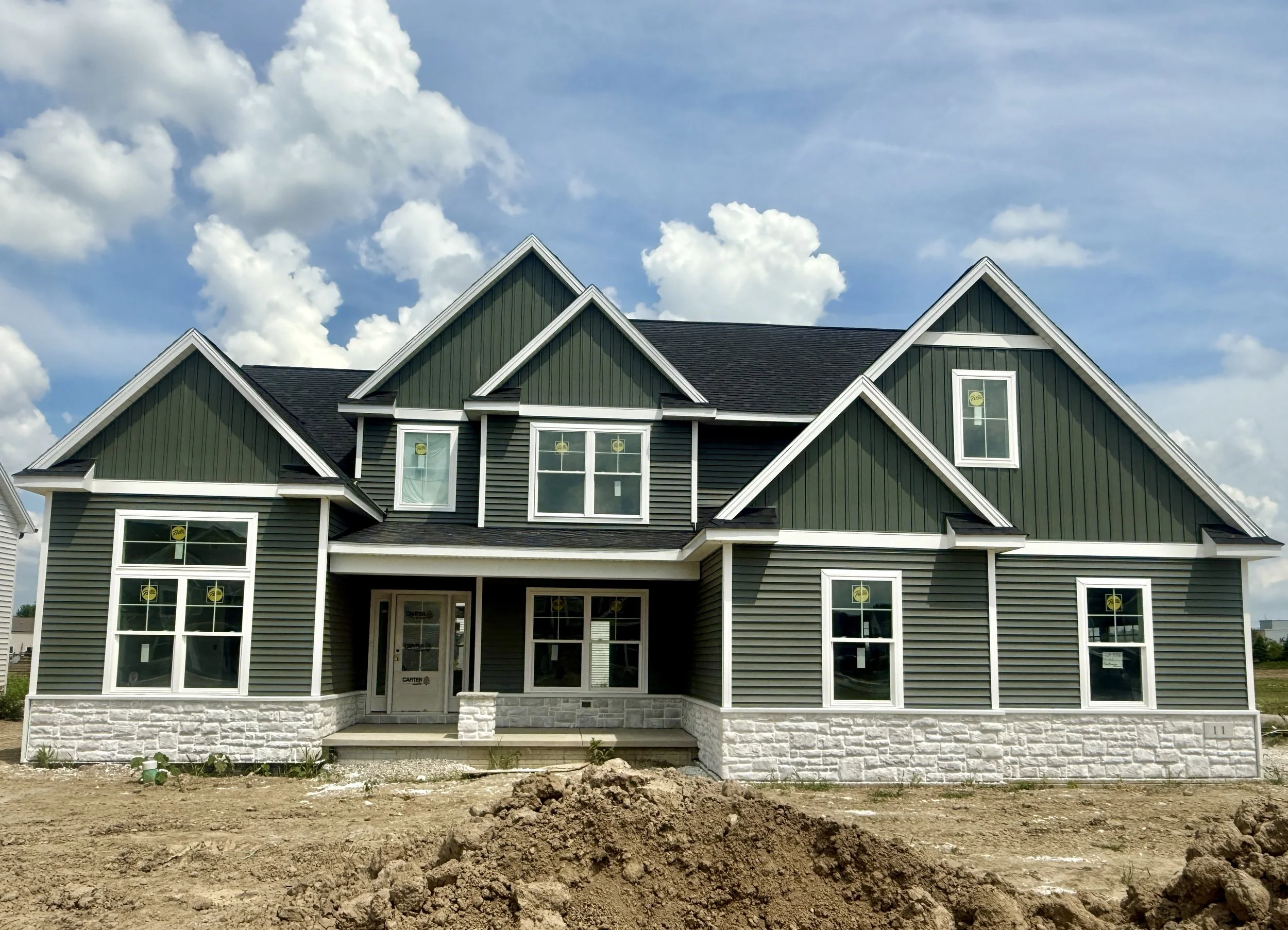 Newly constructed home with dirt before the exterior enhancement 