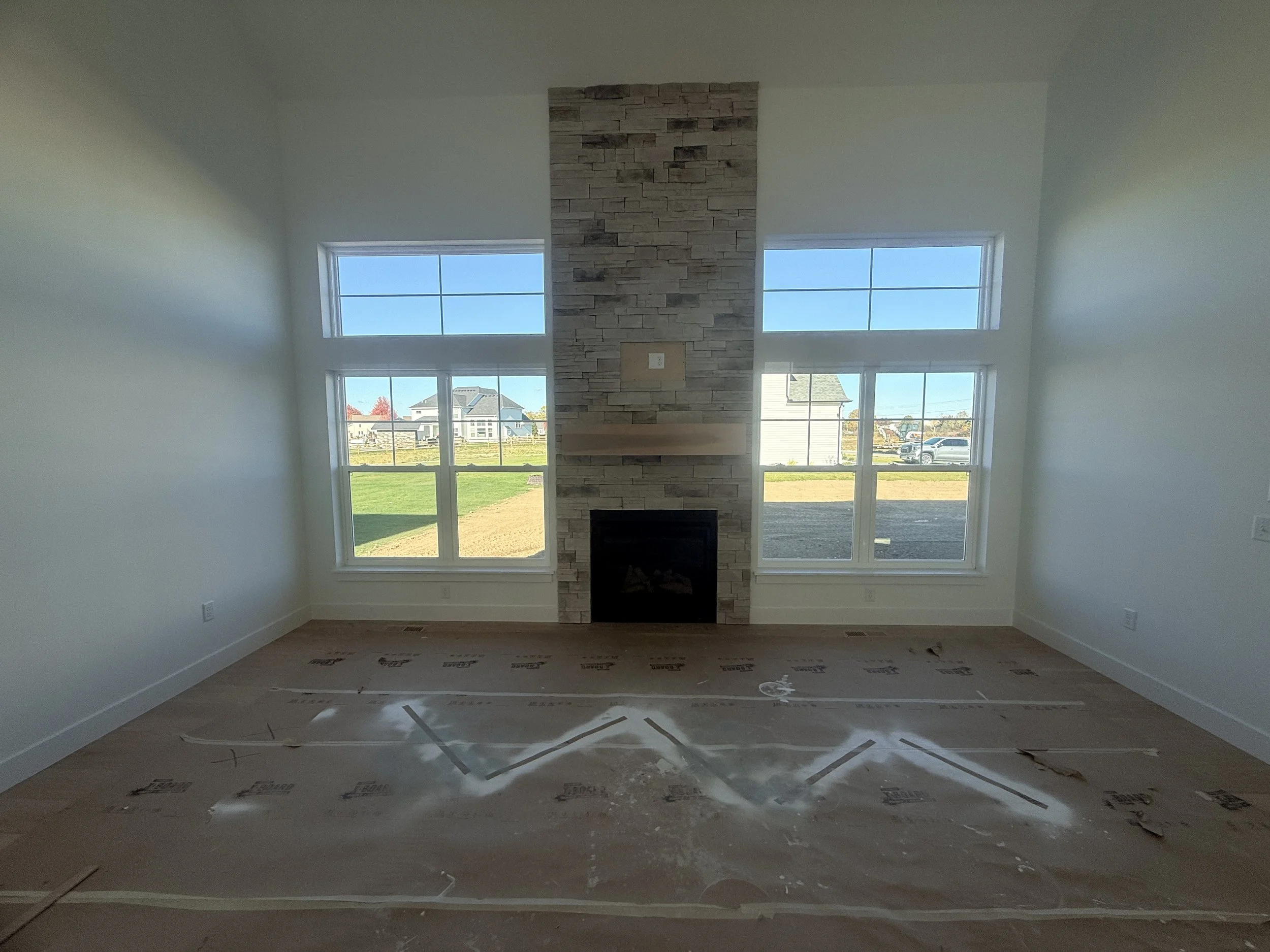 Before and after photo of under-construction home completed digitally.