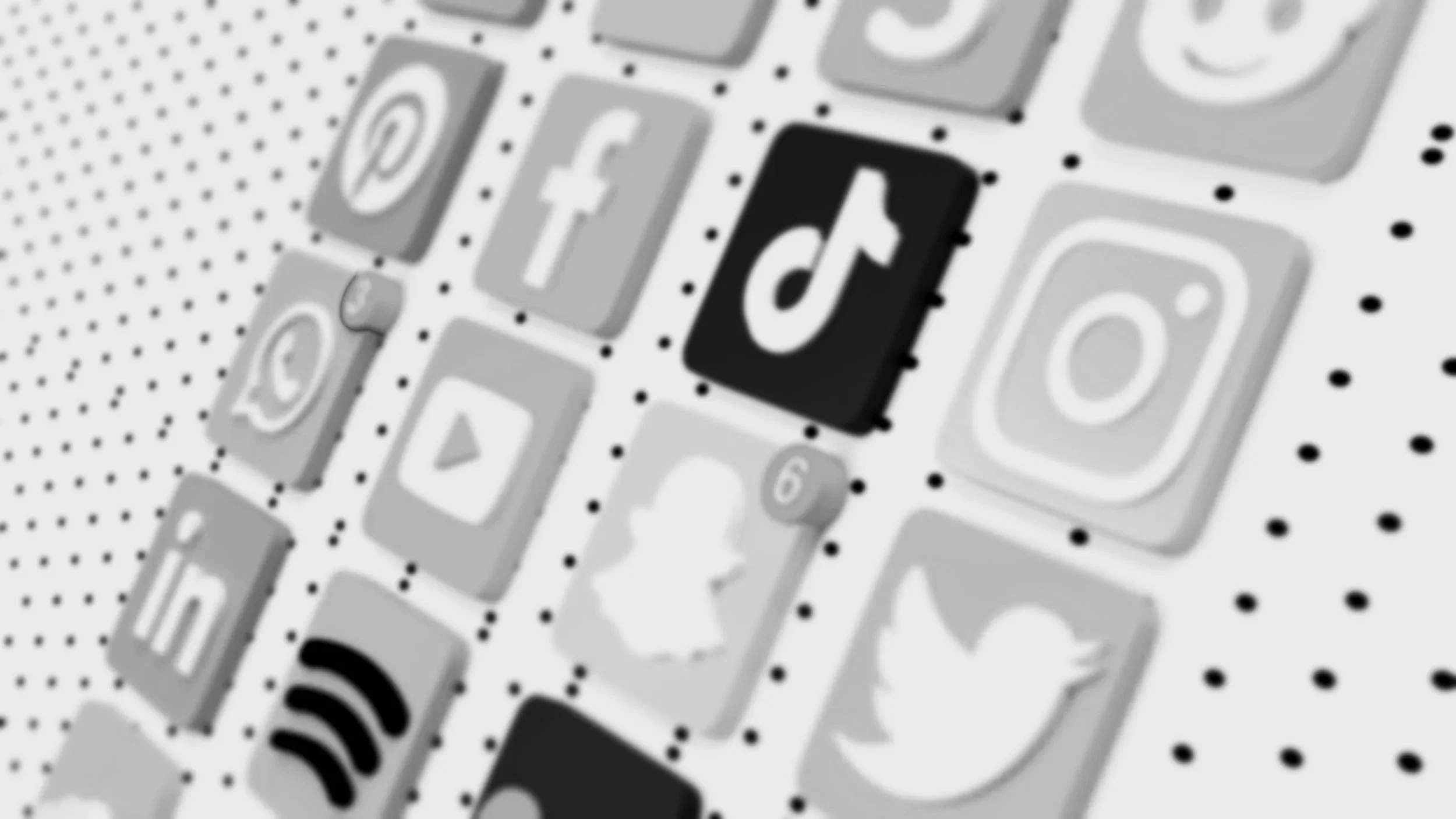 Close-up of a screen displaying various social media app icons, including TikTok, Facebook, Instagram, Twitter, and YouTube.