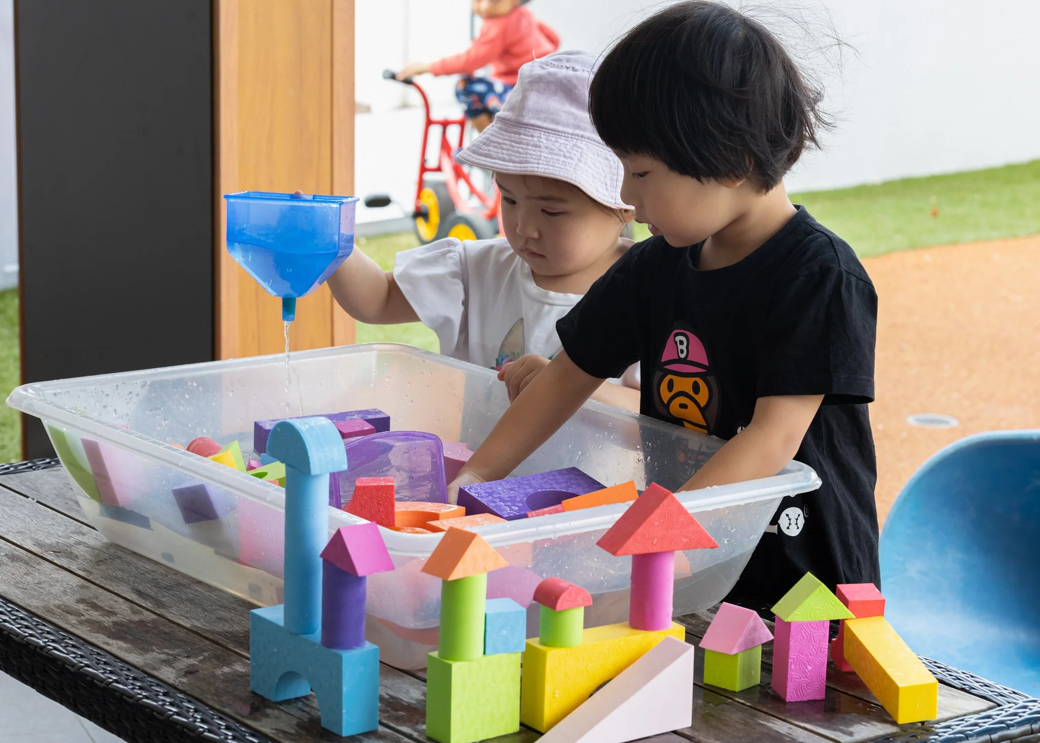 children playing in a water activity outdoors