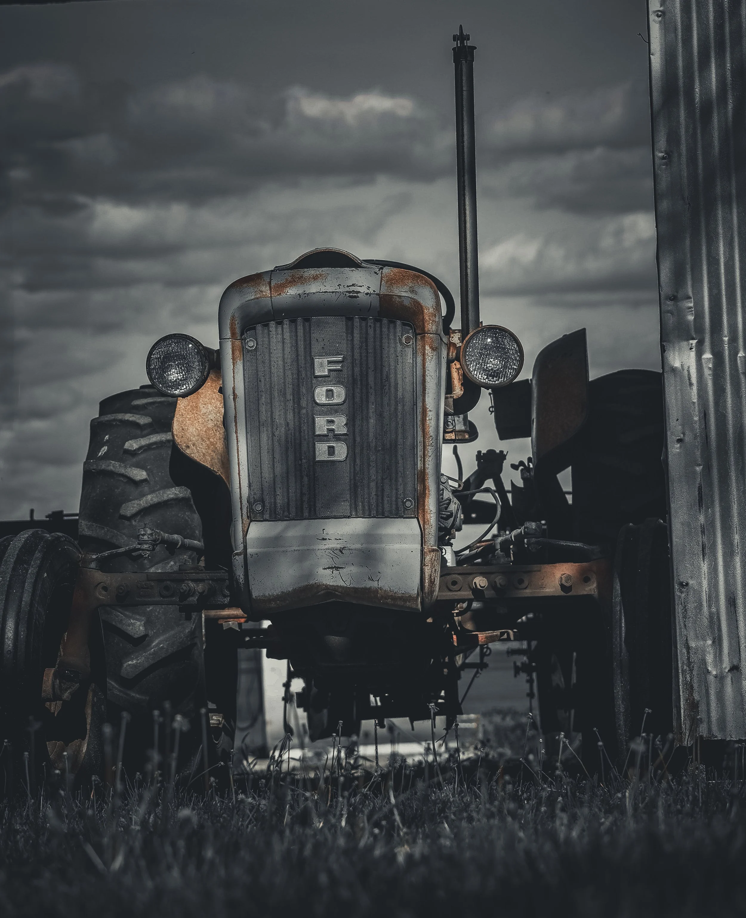 Worn by time and work, this old Ford stands with a steady strength that still feels rooted in the land.