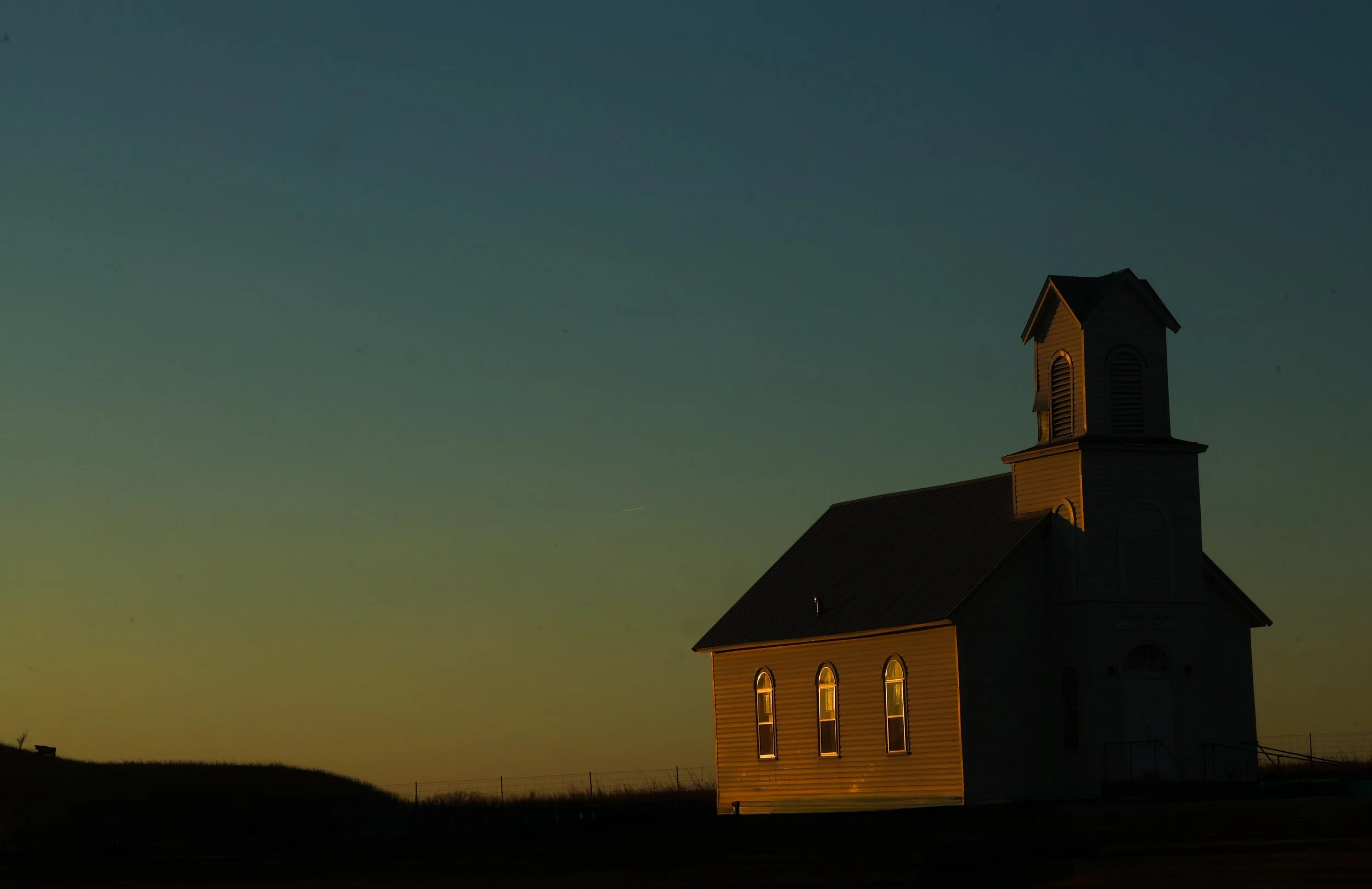 As the day slipped into evening, the church stood glowing like a small and steady grace.
