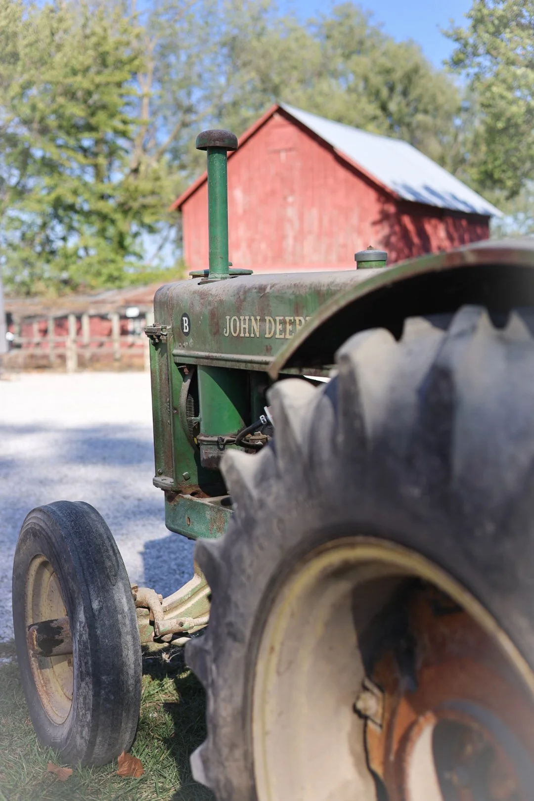 With its weathered paint and the red barn behind it, this John Deere is still a farm classic.