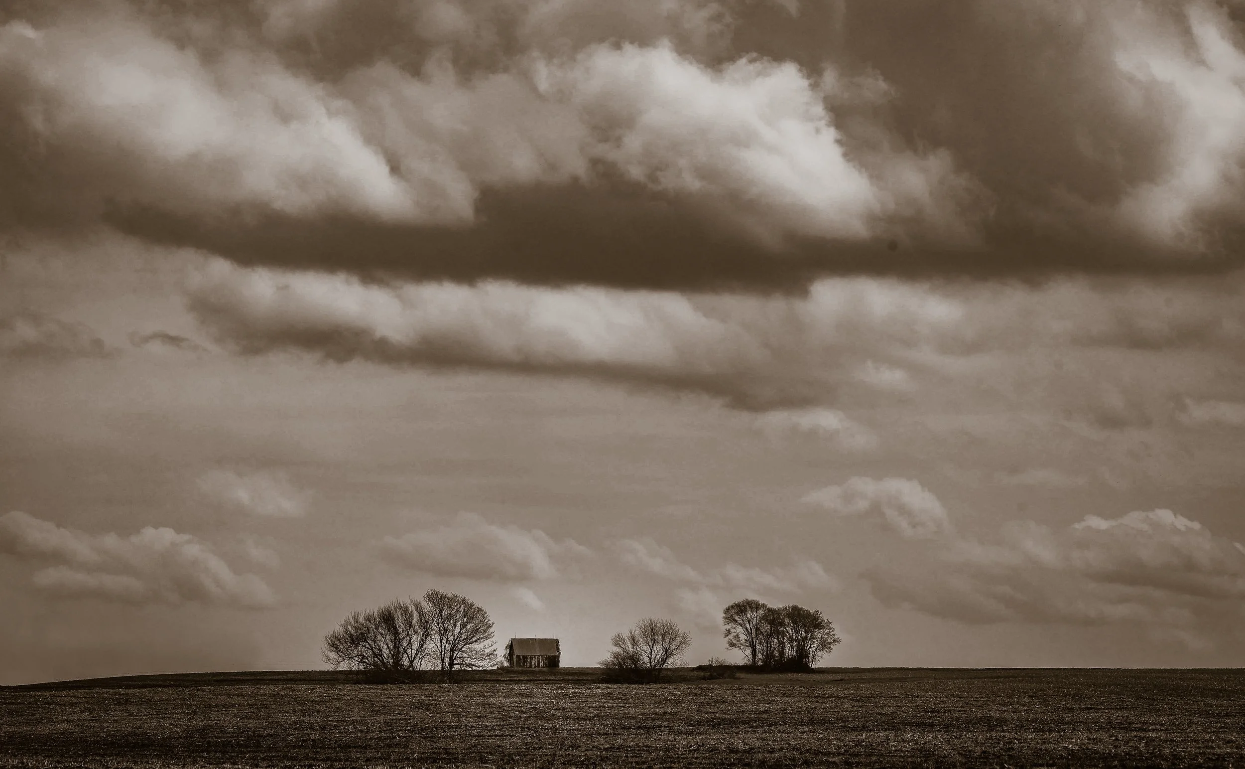 Out on the open prairie, this lone barn sits beneath the weight and wonder of the sky.