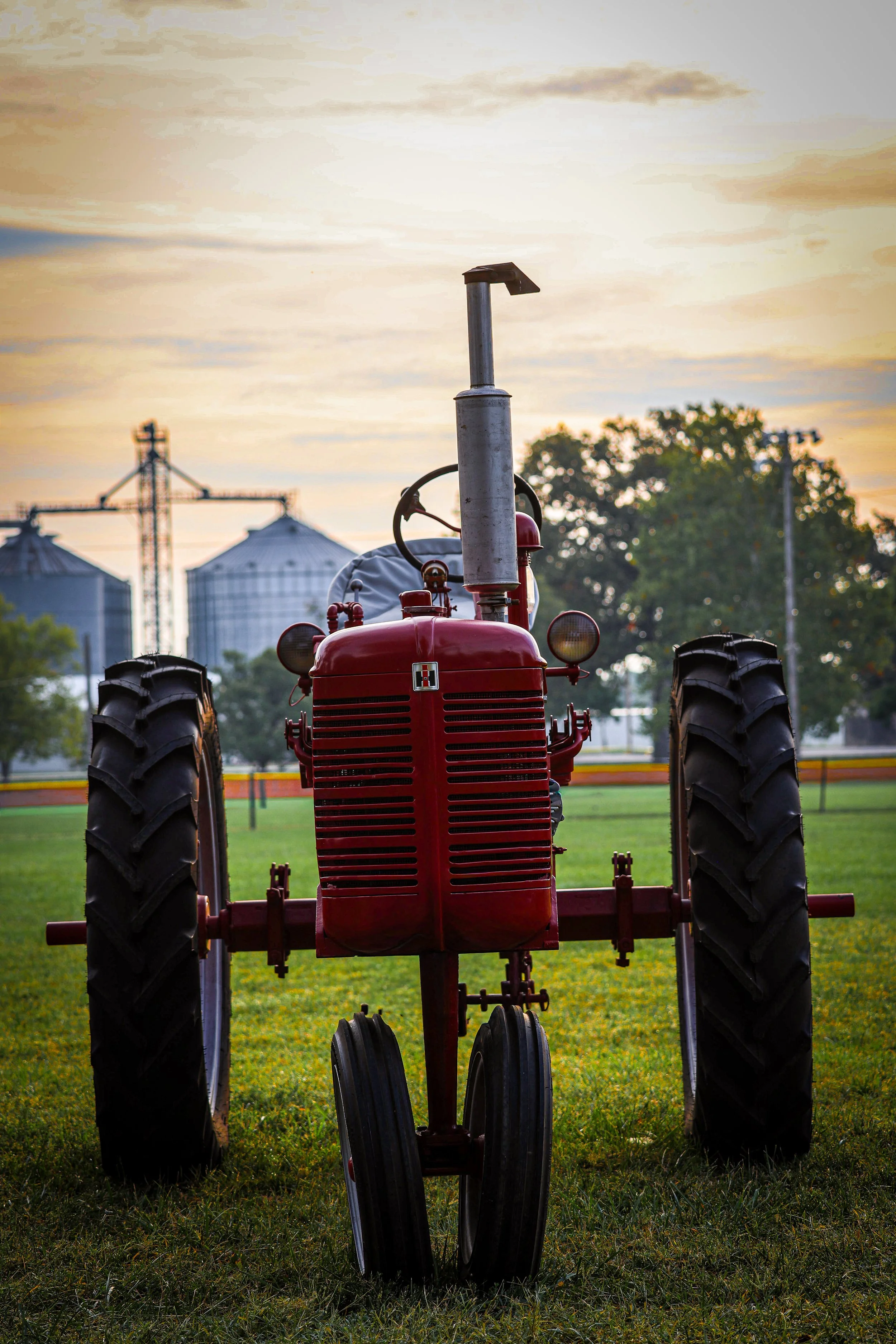Bold against the evening sky, this Farmall holds the lasting spirit of country life.