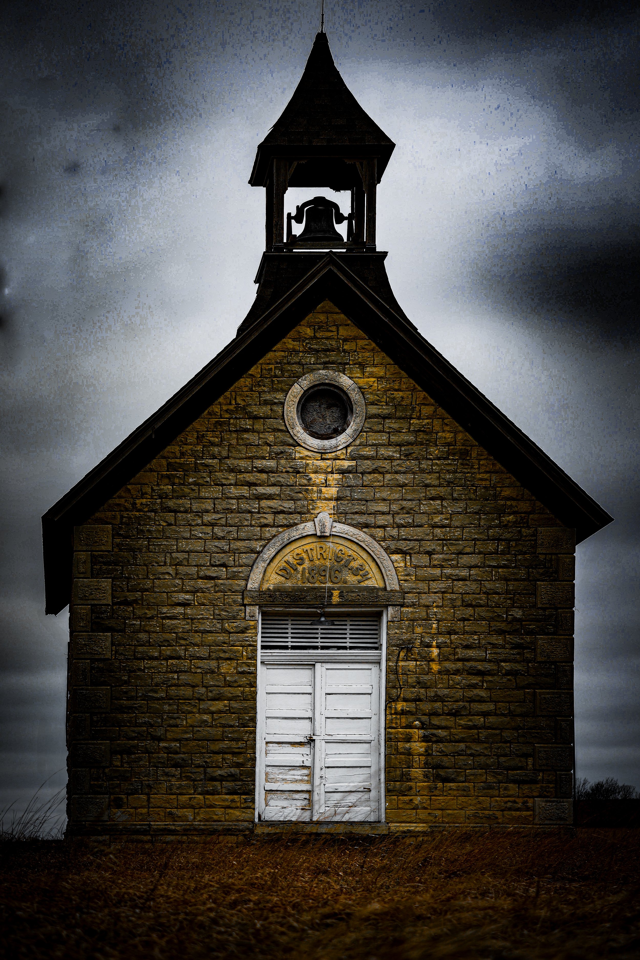 Out on the prairie, this little schoolhouse once gathered country children, their voices, and the start of so many dreams.
