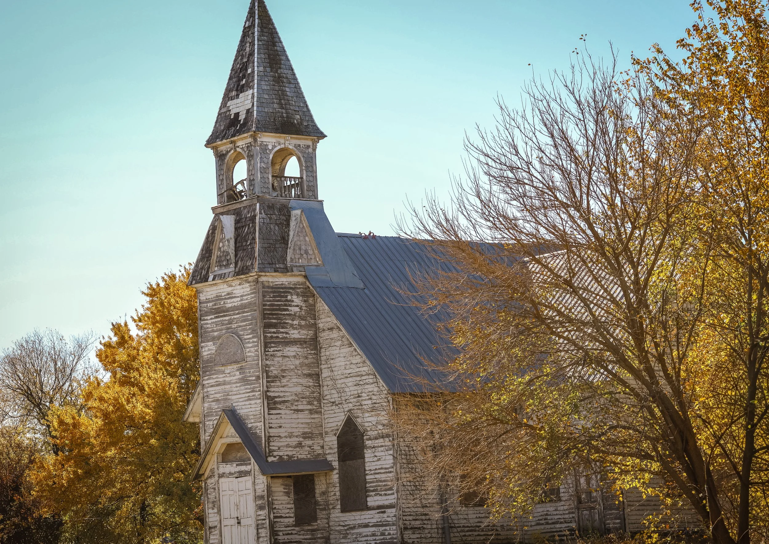 Framed by autumn trees, this old church stands with the kind of grace only time can shape.