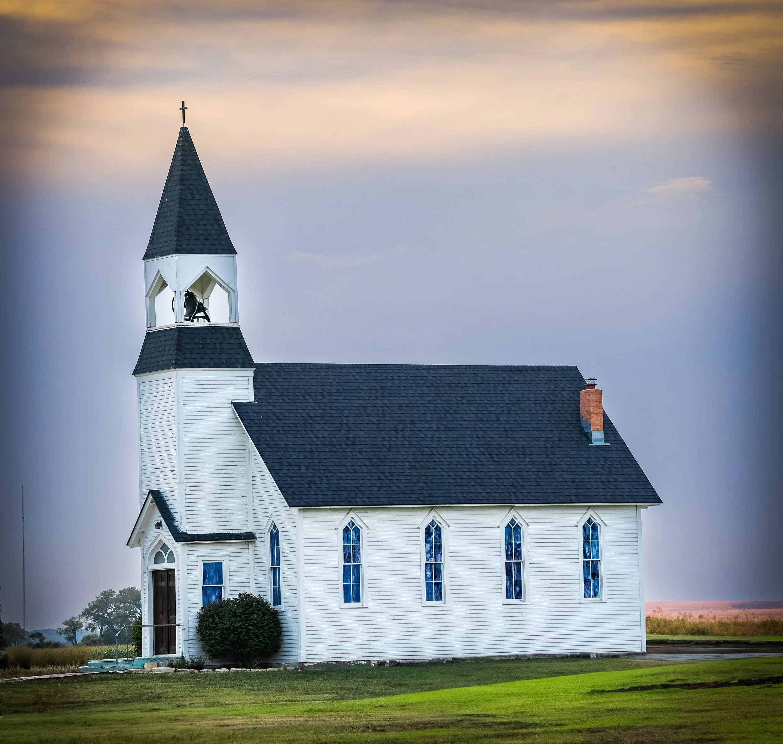 Standing alone on the prairie, this little white church carries a quiet kind of grace.