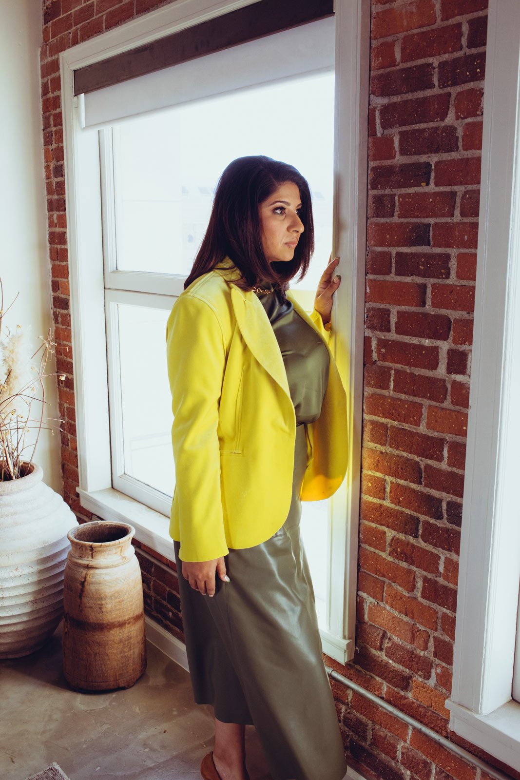 Dr. Payal Beri, PhD, looking out a window. Organizational psychologist, empathy storyteller, cultural strategist, third culture visionary.