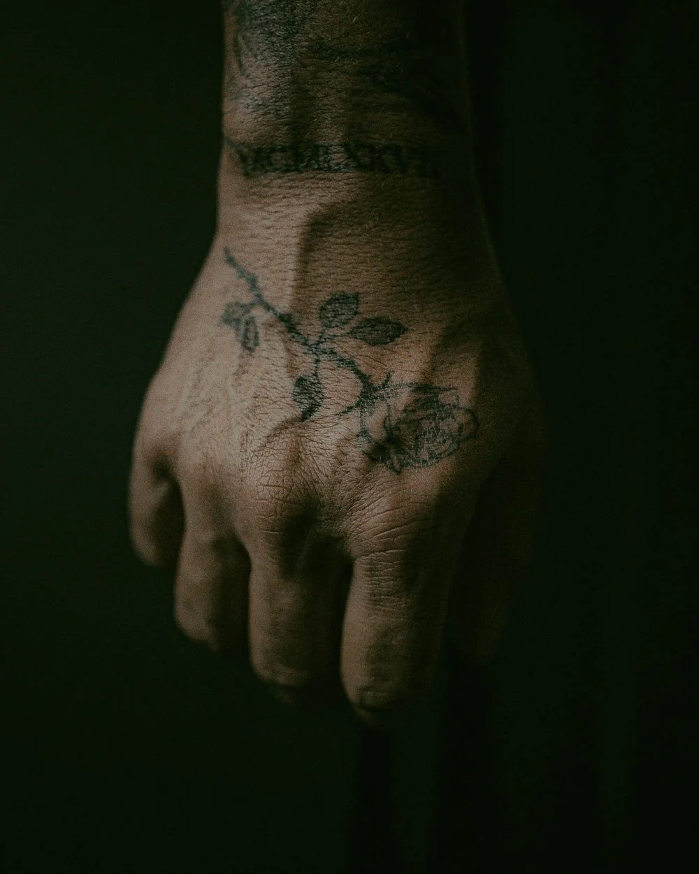 A hand with a tattoo displayed in an artistic way.