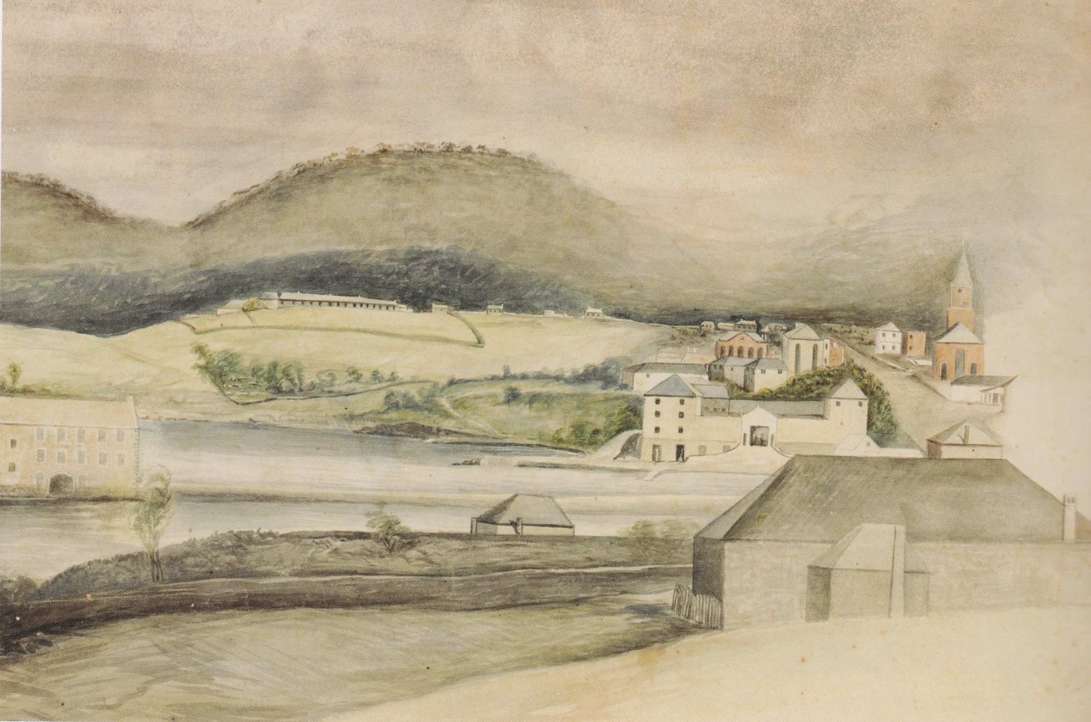 A watercolor painting of a rural village with buildings, a river, and rolling hills and mountains in the background.