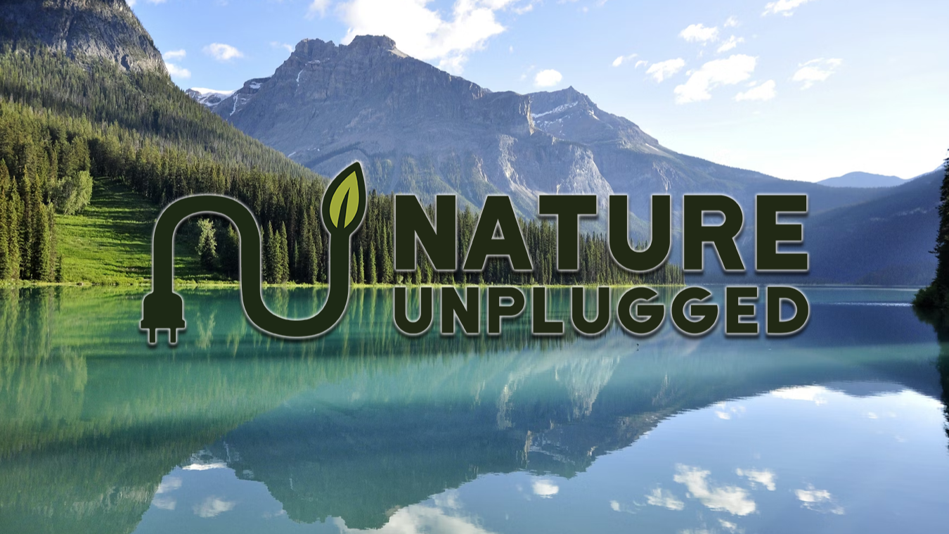An image of a lake with NATURE UNPLUGGED overlayed on top.