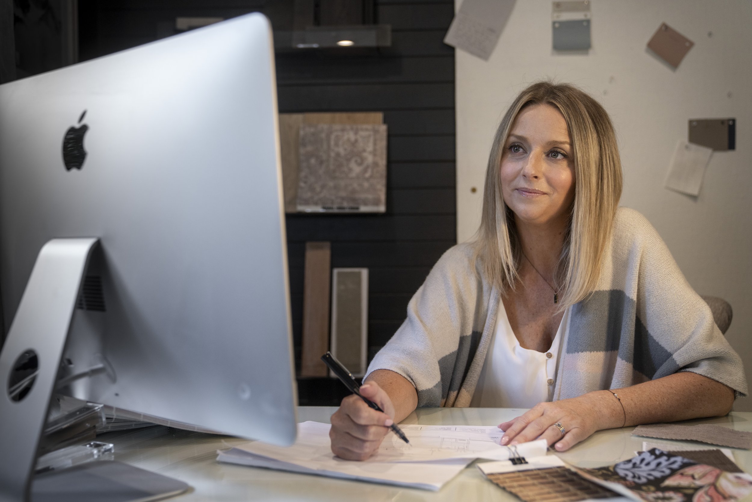 Interior designer at computer designing a kitchen remodel.