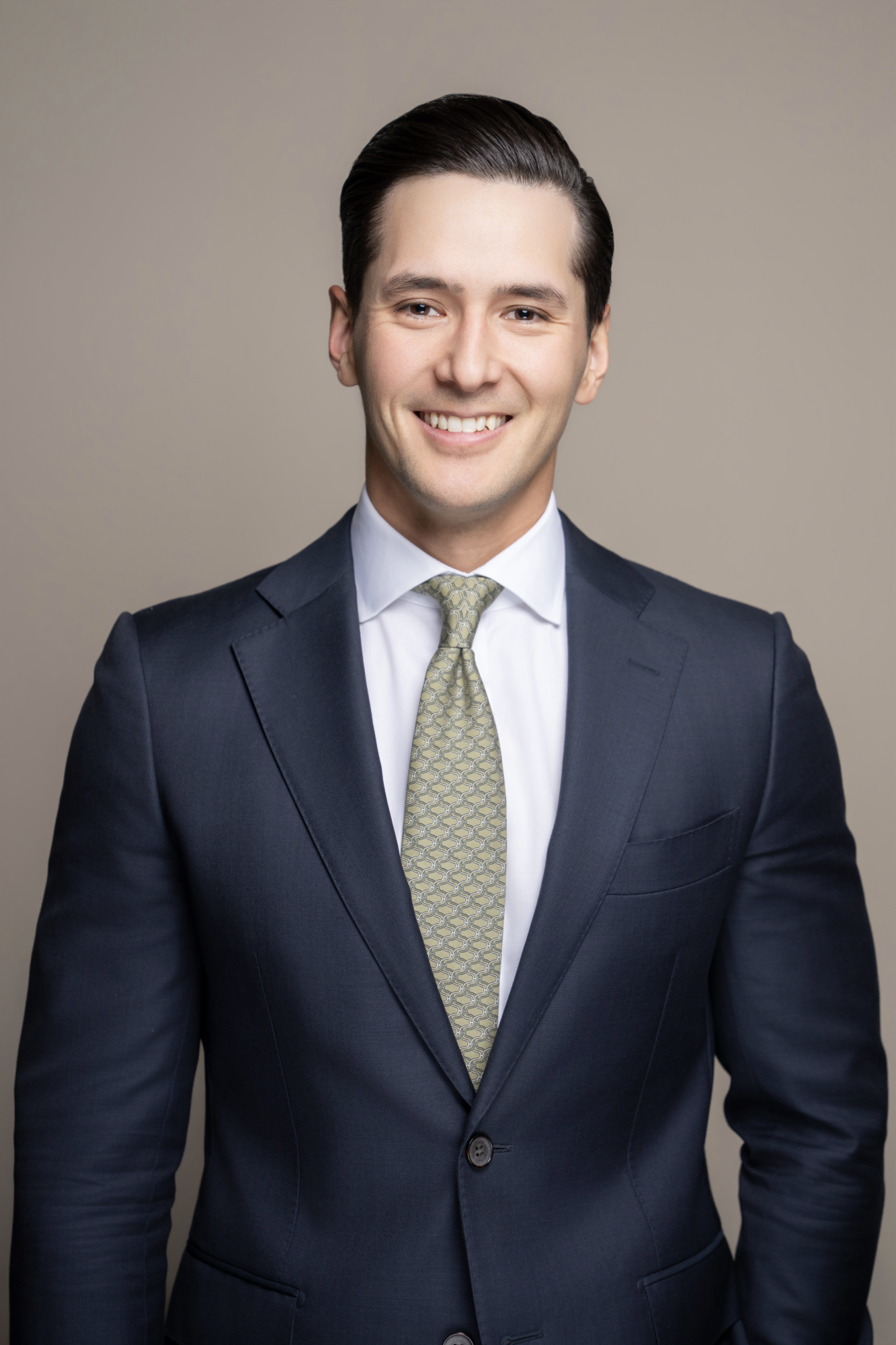 Van A. Carver represents corporations and individuals in white collar defense matters, government investigations, enforcement actions, and complex civil litigations. Man with dark hair in a suit, smiling, against a plain beige background.