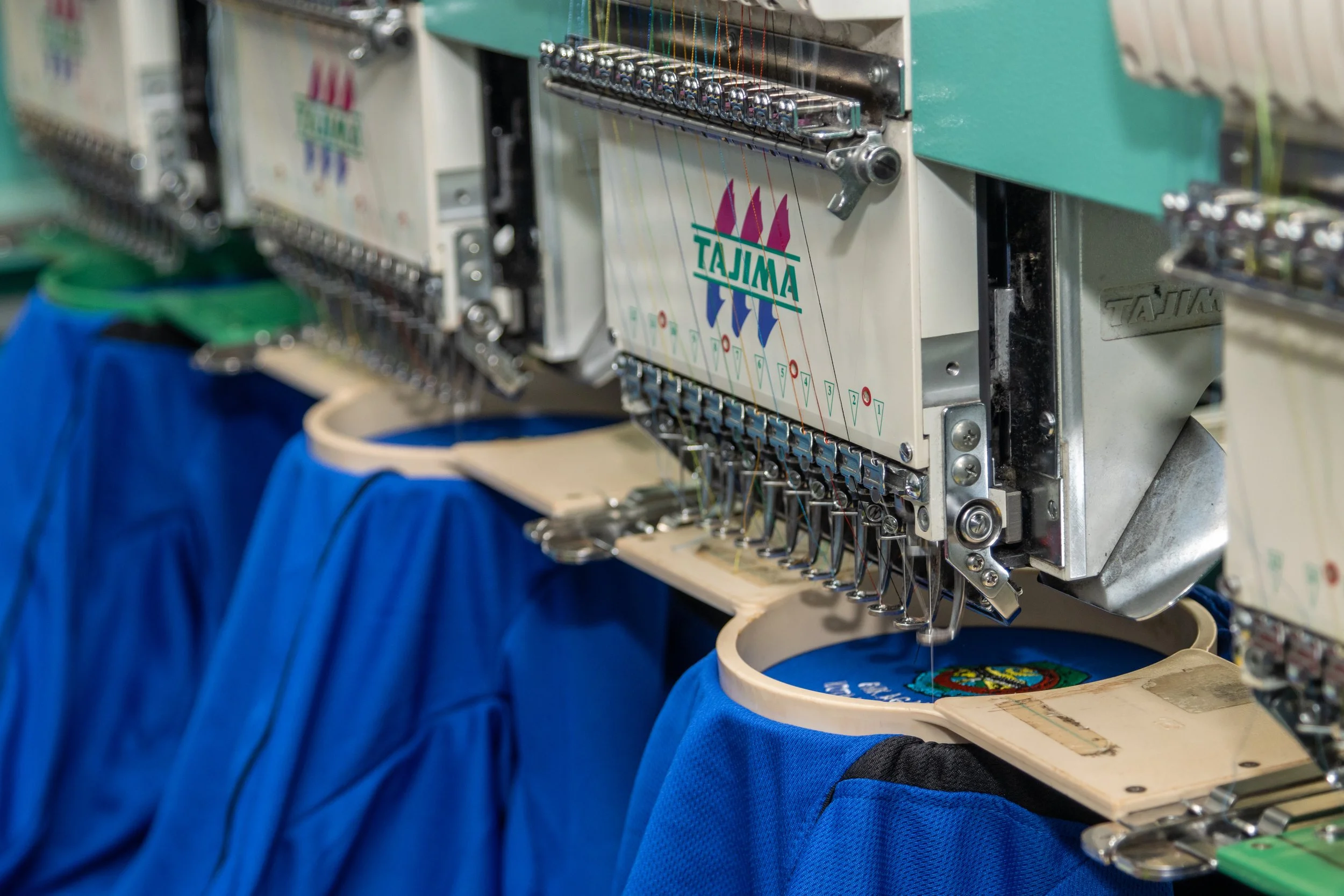 embroidered polo shirts. Tajima embroidery machine. Collective Embroidery.