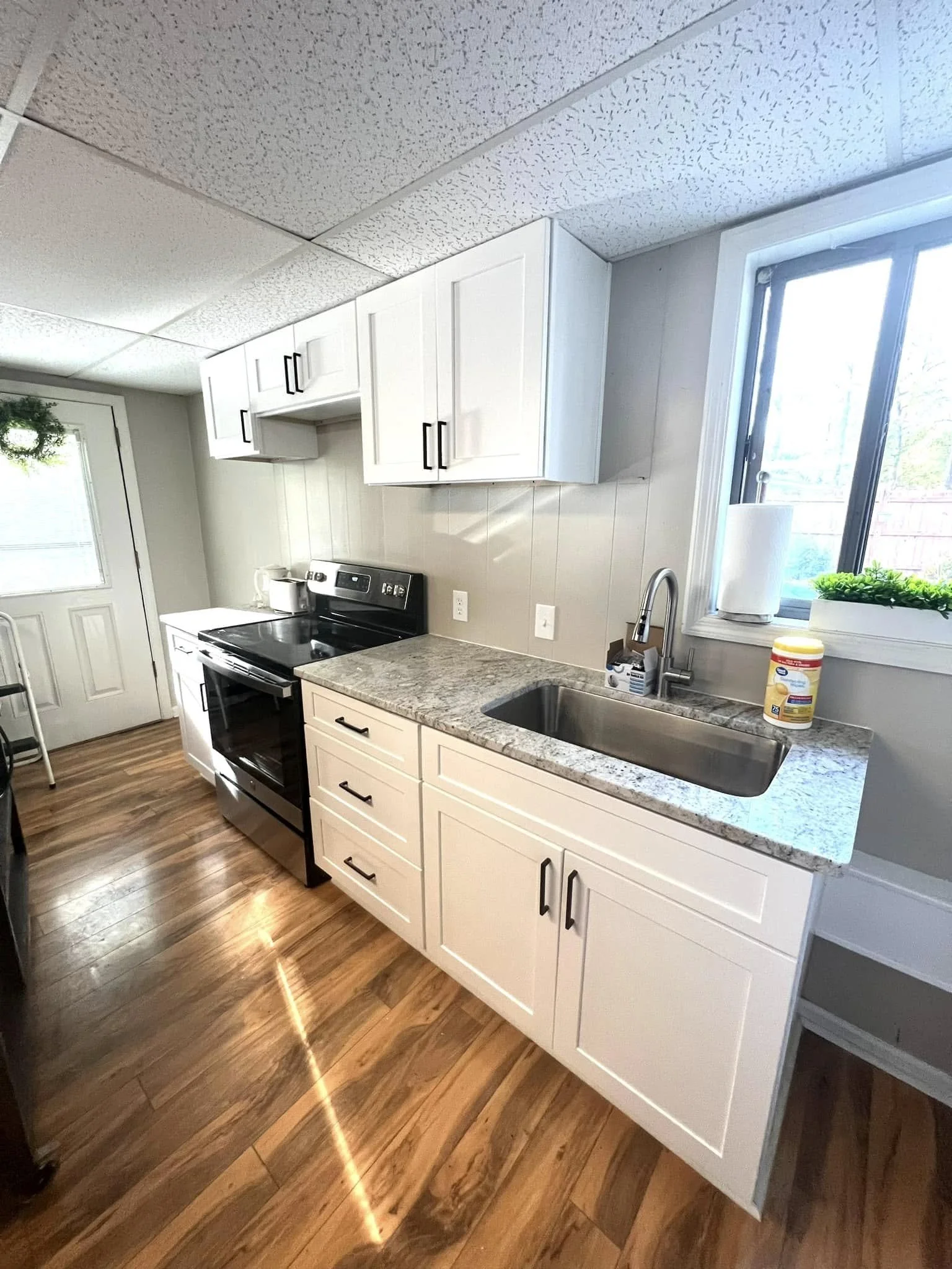 Kitchen remodel in Hernando, MS featuring custom white cabinets, new countertops, and updated flooring by DeSoto Renovations.