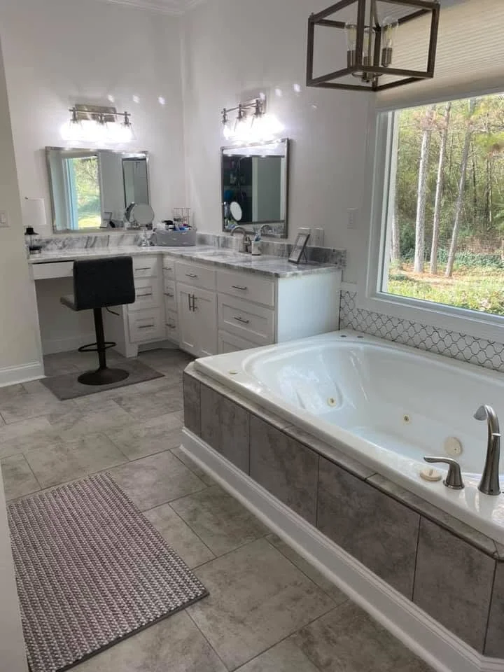 Custom bathroom remodel completed in Hernando, MS by DeSoto Renovations featuring a walk-in tile shower and double vanity.