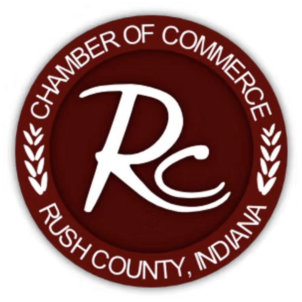 Seal of the Rush County, Indiana Chamber of Commerce with a maroon background and white text and design.