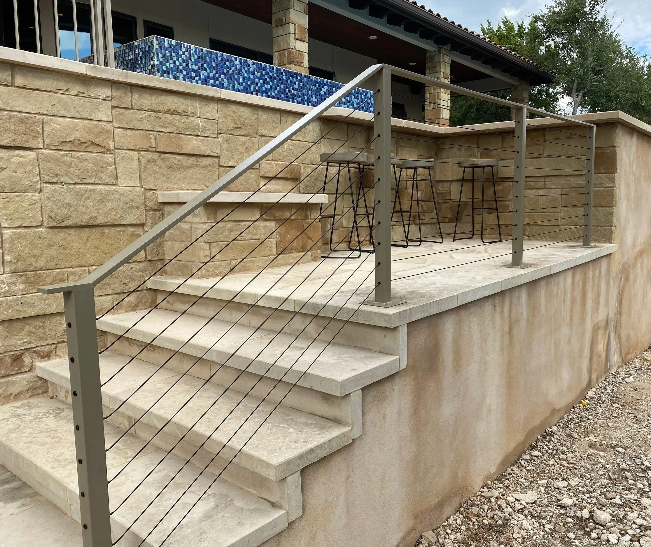 Steel railing with cables powder coated tan.